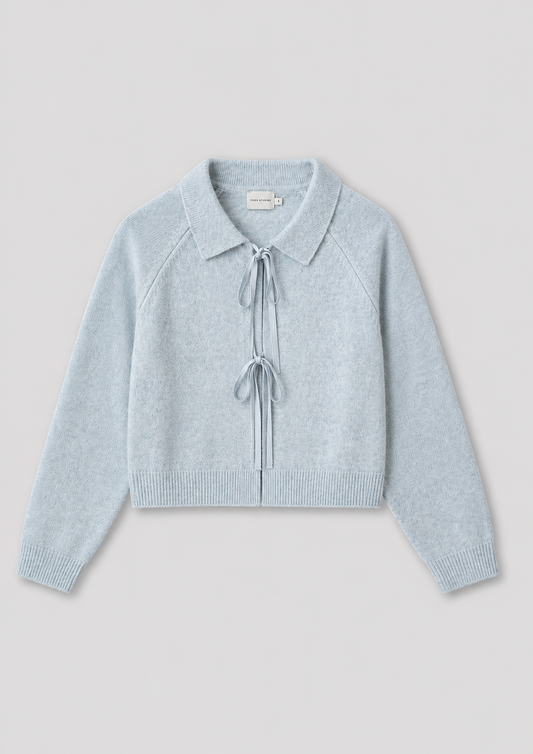 The Box Cardigan - Young Blue is a light blue, long-sleeve knit cardigan featuring a collar and two front tie closures at the chest and waist, inspired by Deiji Studios, shown on a plain light gray background.