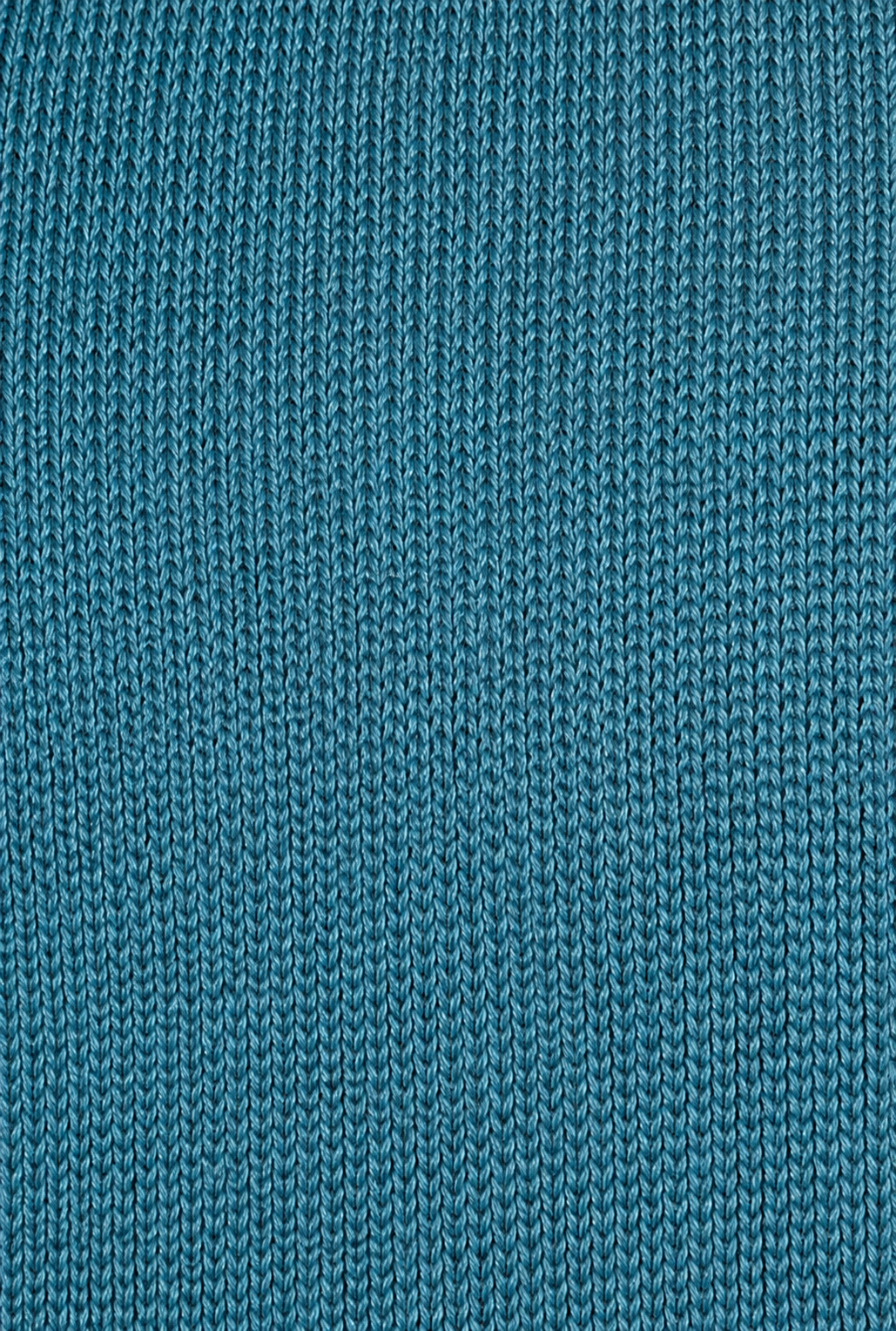 Close-up of the Aqua Cross Top, featuring teal-colored knitted fabric with a repeating vertical ribbed pattern. The even, tight stitches create a textured surface that’s perfect for adjustable self-tie straps.