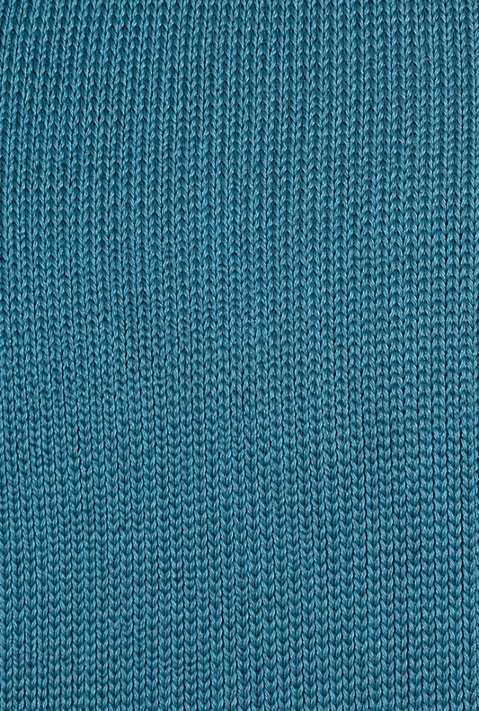 Close-up of the Aqua Cross Top, featuring teal-colored knitted fabric with a repeating vertical ribbed pattern. The even, tight stitches create a textured surface that’s perfect for adjustable self-tie straps.