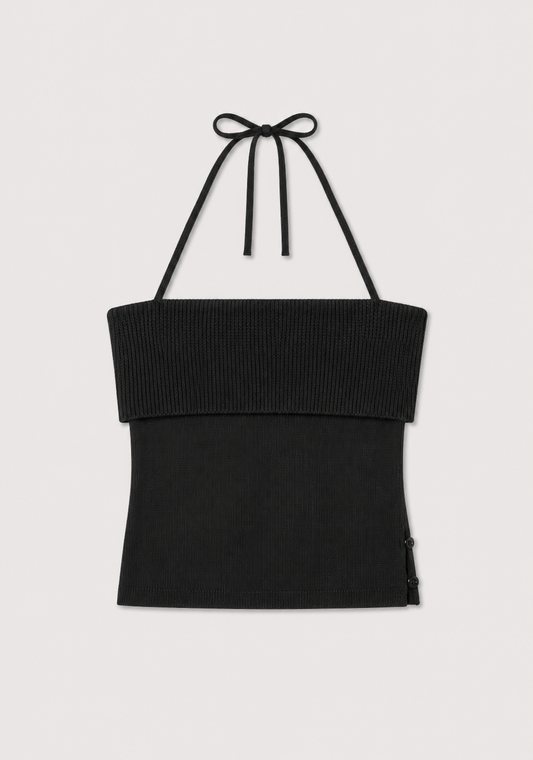 Half Top - Black from Deiji Studios, a black ribbed knit halter top featuring a wide, folded-over band at the chest and thin halter straps tied in a bow at the neck, displayed flat on a light background.