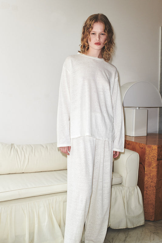 Female model wearing soft pant - ecru by Deiji Studios against plain background