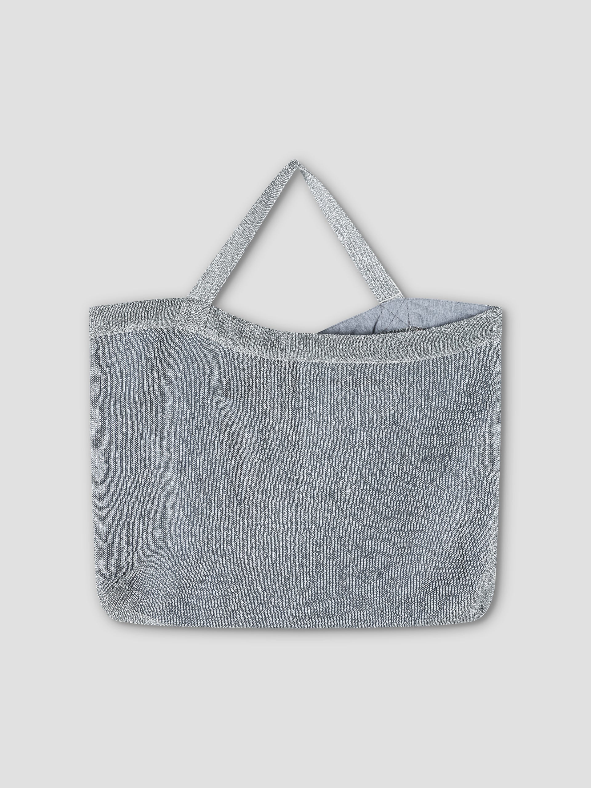 The Chain Bag - Silver, a metallic mesh shoulder bag with two handles, is showcased against a plain light gray background.