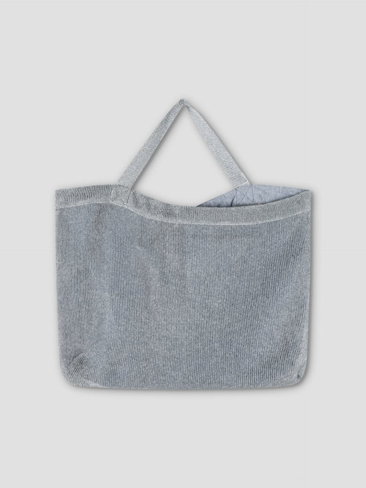 The Chain Bag - Silver, a metallic mesh shoulder bag with two handles, is showcased against a plain light gray background.