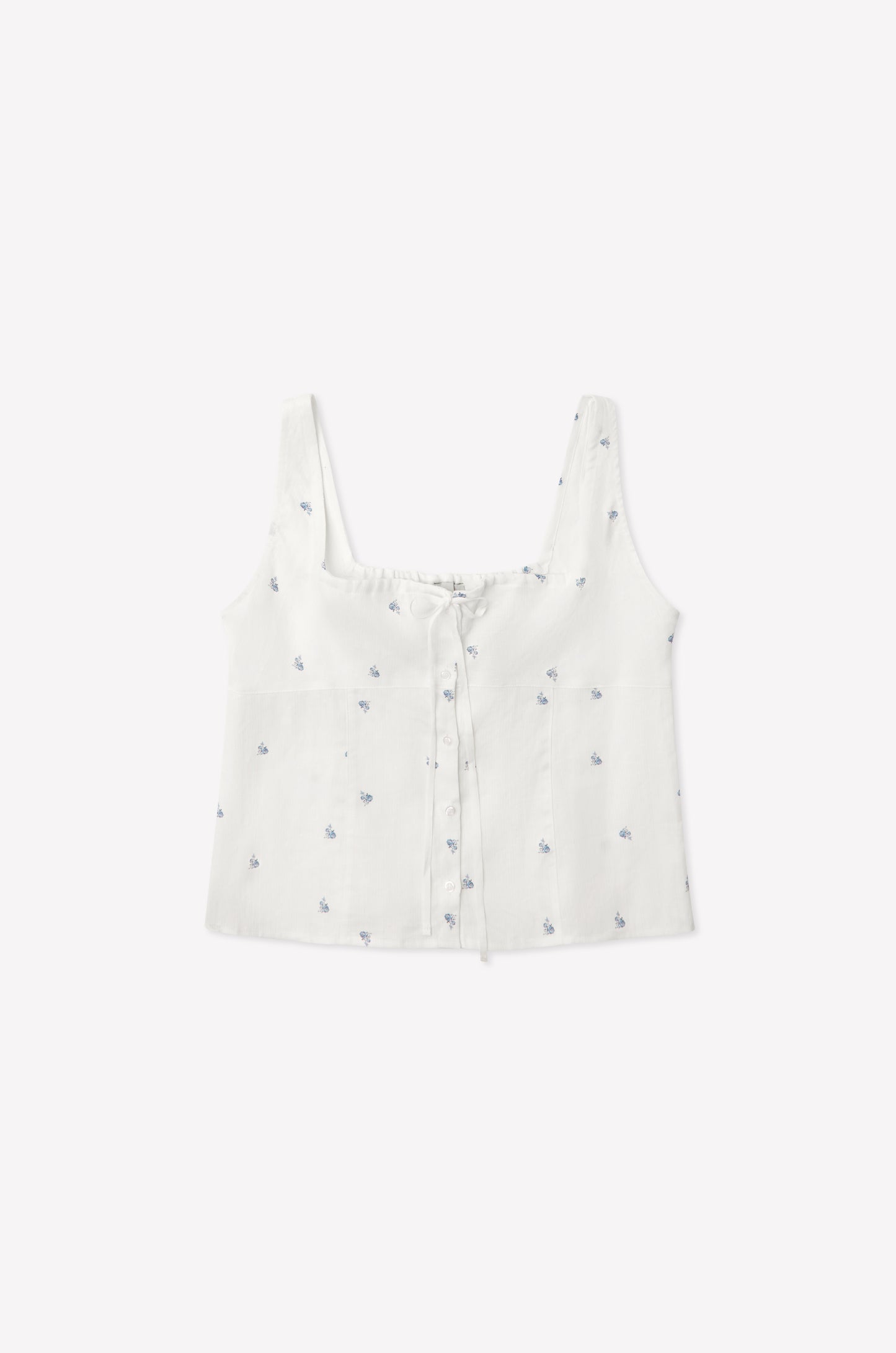 The Relax Short Set - Floral Blue features a white sleeveless crop top with a square neckline, blue floral prints, front buttons, and a drawstring chest detail—shown laid flat on a plain white background.