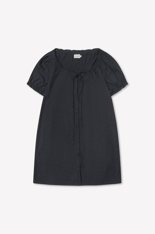 Buttoned Mini Dress - Mono Grid: short-sleeved, dark checkered dress with flounced sleeves, round neckline, front buttons, and neck tie detail, displayed flat on a white background.