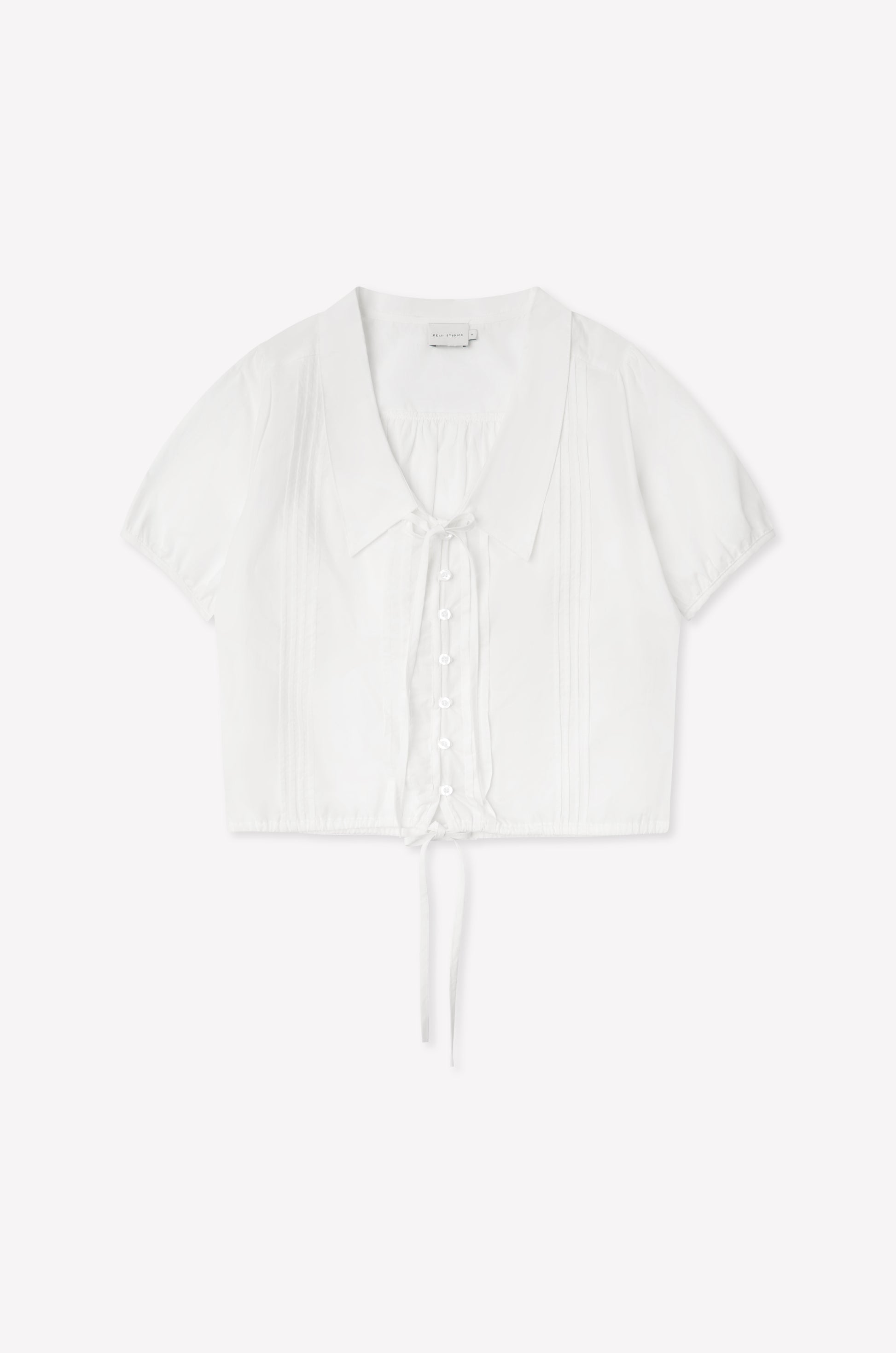 The Fine Collar Top - White features a collared v-neck, short sleeves, button-down front, pintuck details, and a waist tie—crafted from cotton poplin with signature Deiji Studios elegance.