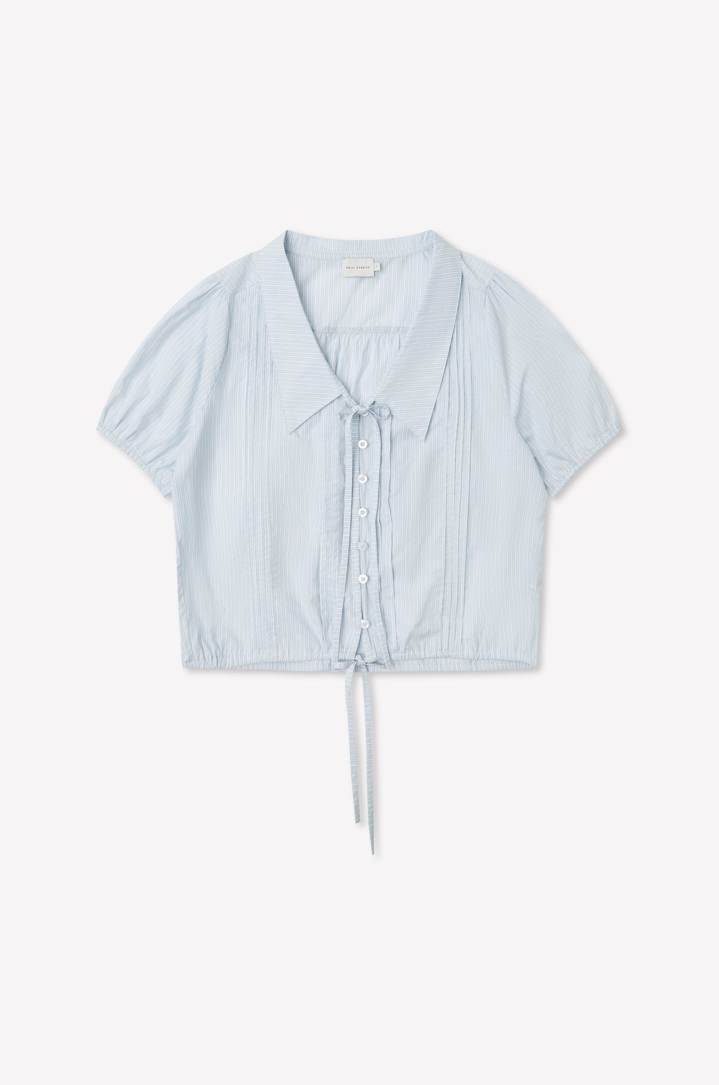 The Fine Collar Top - Mist Stripe features a light blue vertical stripe design, short sleeves, fine collar, button-down front, and drawstring waist. Made from lightweight cotton poplin for a casual, airy look inspired by Deiji Studios.