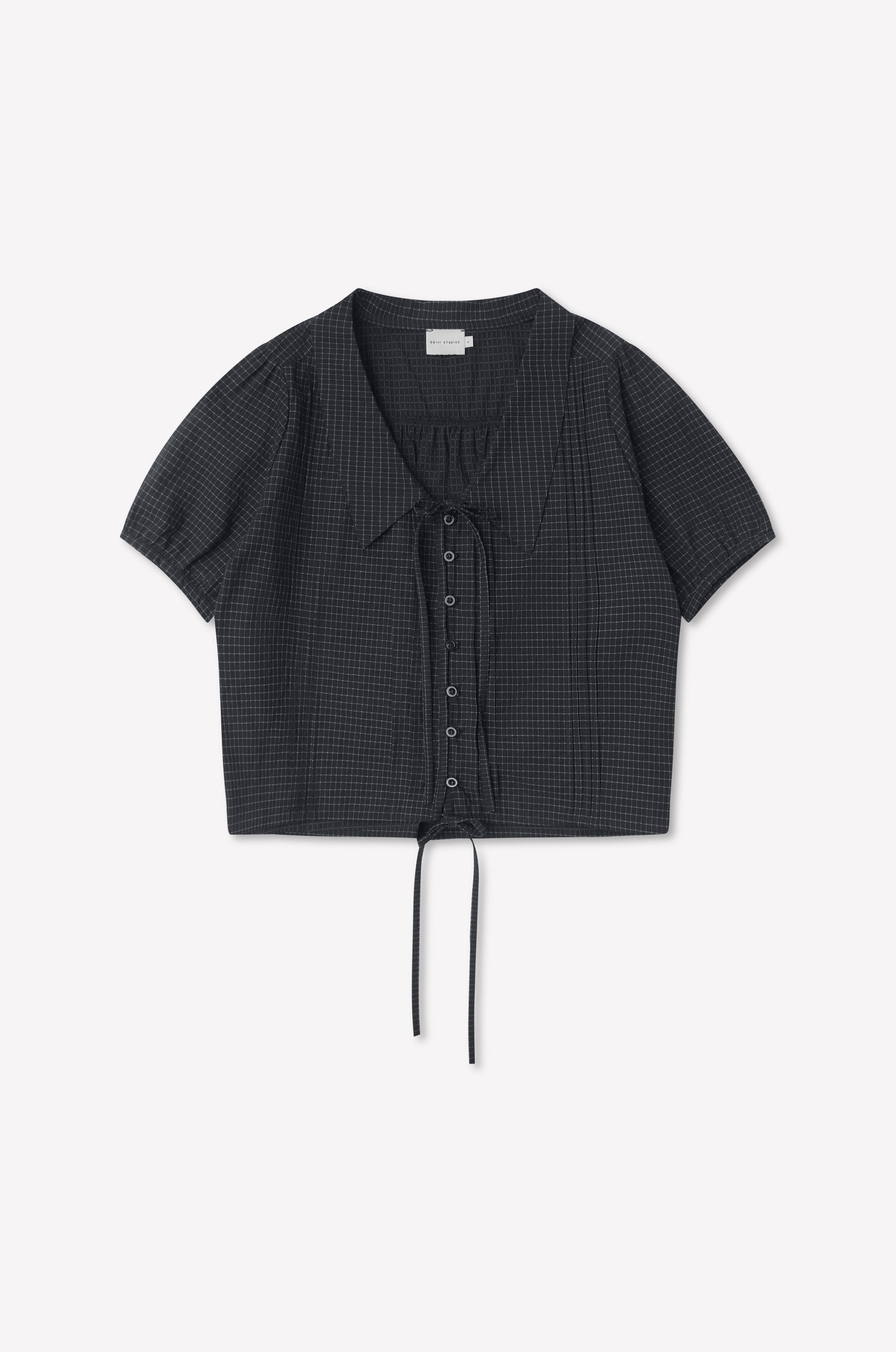 The Fine Collar Top - Mono Grid is a short-sleeved, charcoal gray cotton poplin top with a subtle grid pattern, collared v-neck, and drawstring at the cropped hem, shown laid flat on a white background.