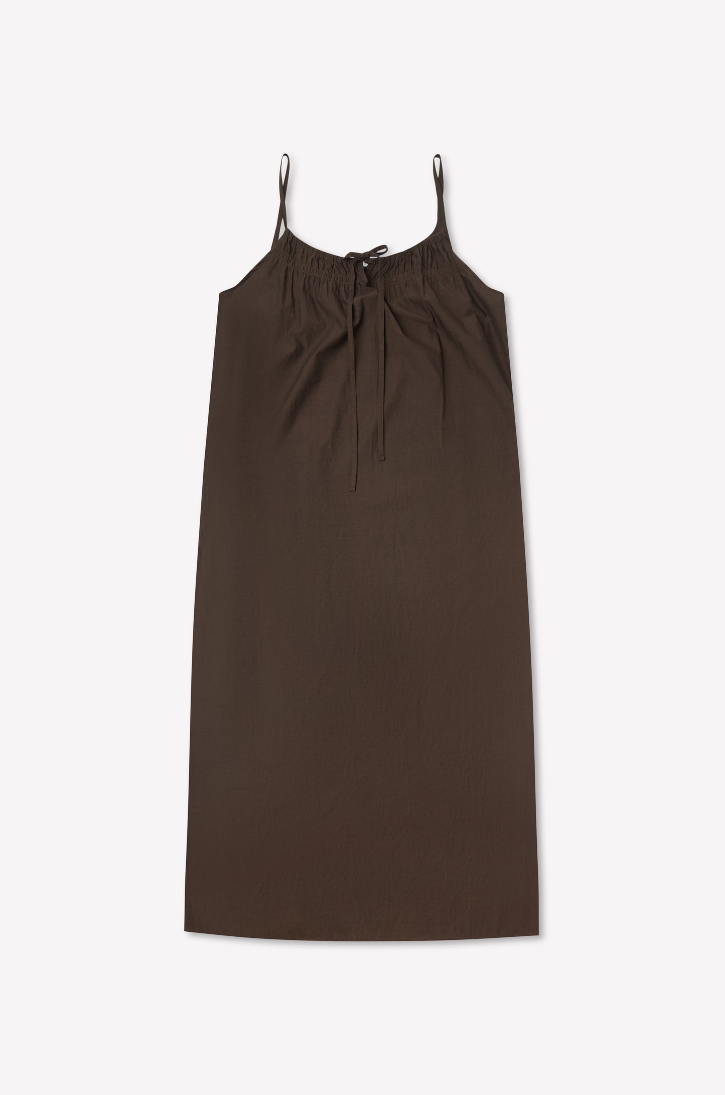 The Light Maxi Dress - Toast by Deiji Studios is a sleeveless, knee-length brown dress with thin straps and a gathered neckline tied with a bow, shown flat on a light background.