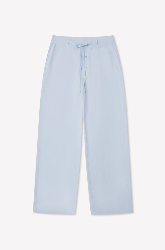 Powder blue Panel Leg Pant by Deiji Studios featuring a wide-leg silhouette, drawstring waist, front button closure, and side pockets, shown laid flat on a white background.