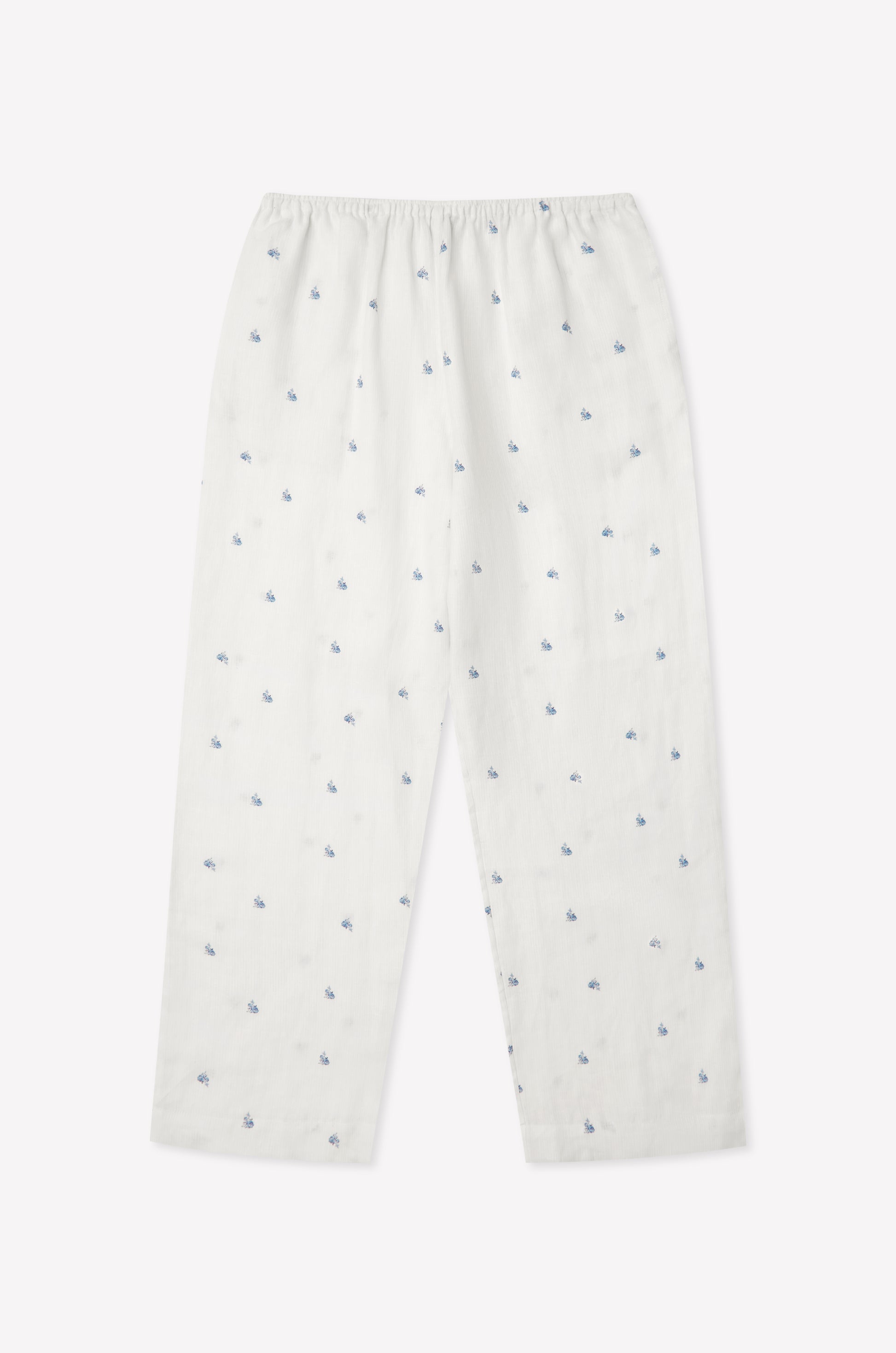 The Linen Ease Trouser - Floral Blue features a relaxed fit, elastic waist, and an evenly distributed blue floral print on white linen, shown against a plain light background.