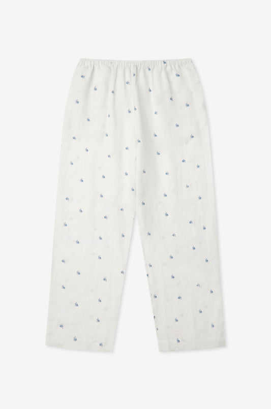 The Linen Ease Trouser - Floral Blue features a relaxed fit, elastic waist, and an evenly distributed blue floral print on white linen, shown against a plain light background.