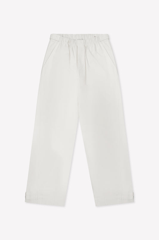 The Snap Tab Pant - White features a loose, wide-leg fit with an elastic waistband and side pockets, shown flat on a white background.