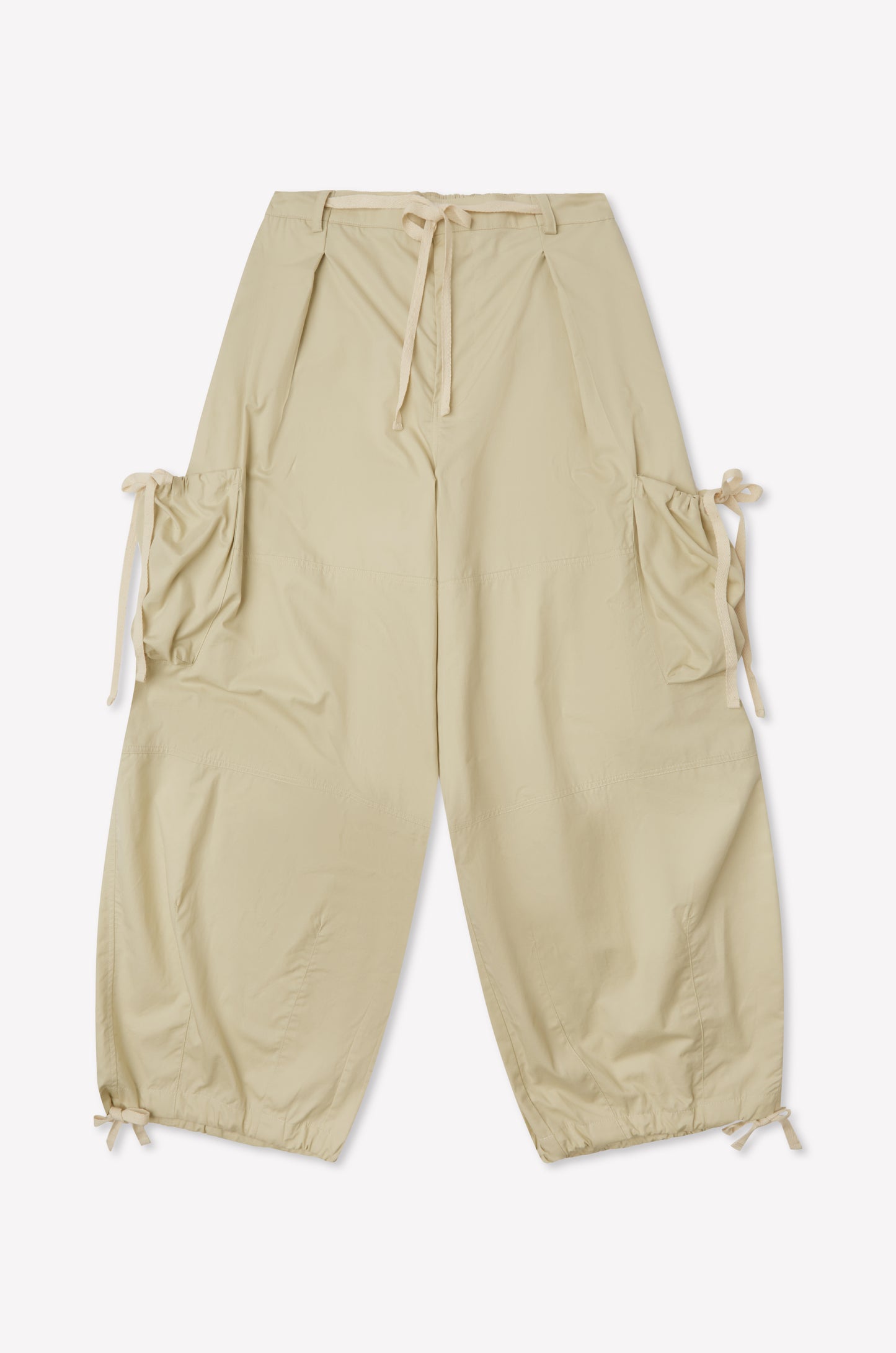 Cargo Pant - Stone by Deiji Studios in beige features a wide-leg silhouette, drawstring waist, large side pockets with drawstring details, and elasticated cuffs. Shown laid flat on a white background.