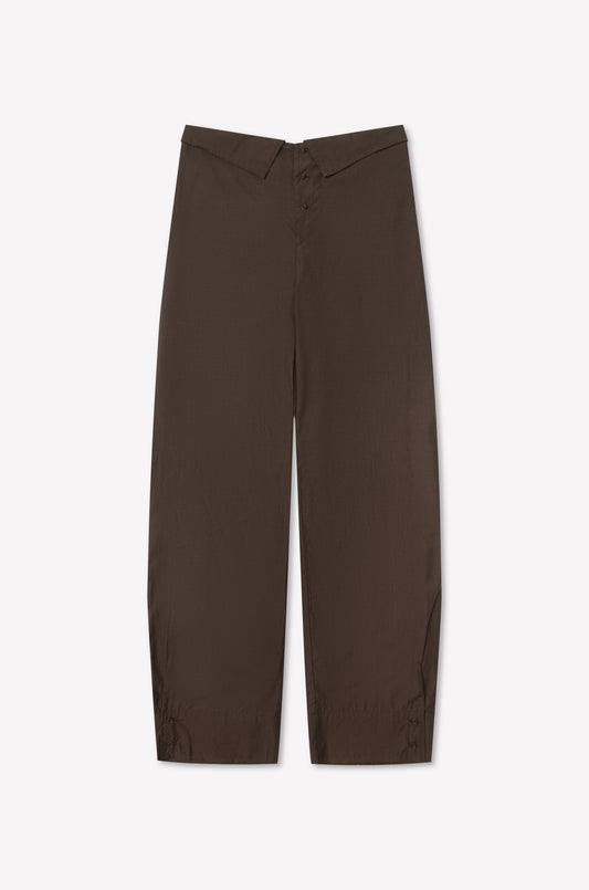 The Collar Point Pant - Toast from Deiji Studios features brown wide legs, a high waist, front button and zipper closure, and subtle ankle seam detailing—shown laid flat on a white background.