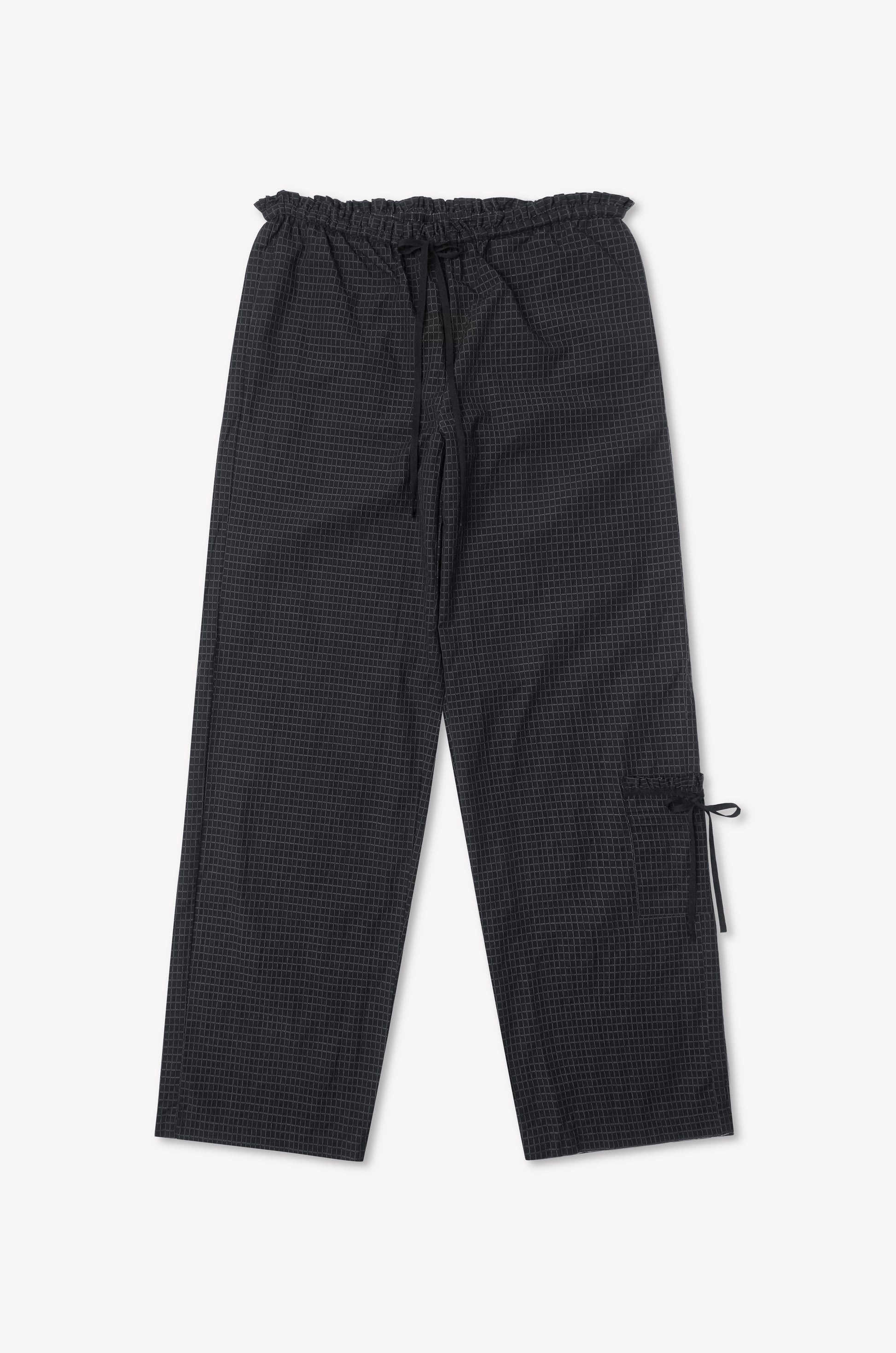 The Grosgrain Pant - Mono Grid is a loose-fit black checkered pant with relaxed legs, a drawstring waist, side pocket with tie detail, inspired by Deiji Studios, shown on a white background.