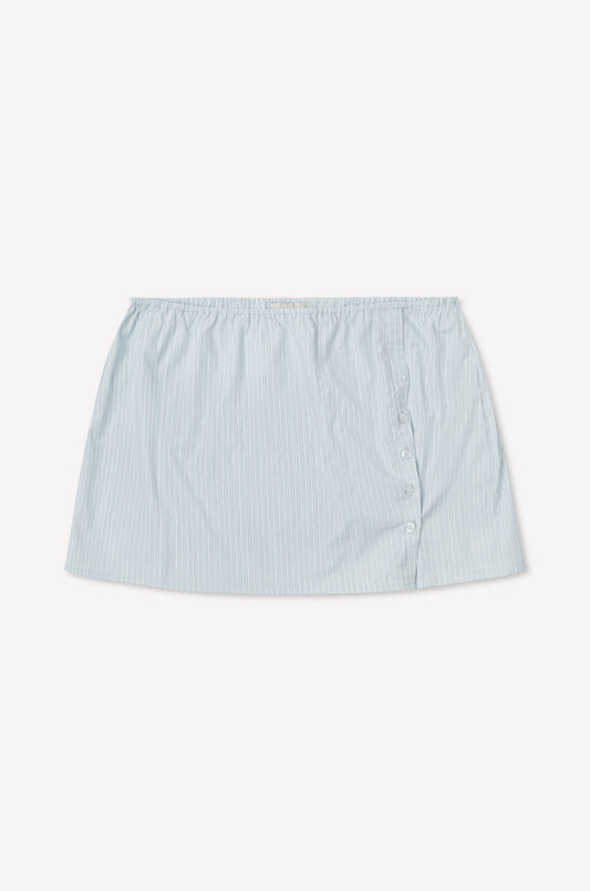 The Pleat Split Skirt - Mist Stripe is a light blue cotton poplin mini skirt with pinstripes, an elastic waistband, and three side buttons, shown on a white background. Inspired by Deiji Studios.
