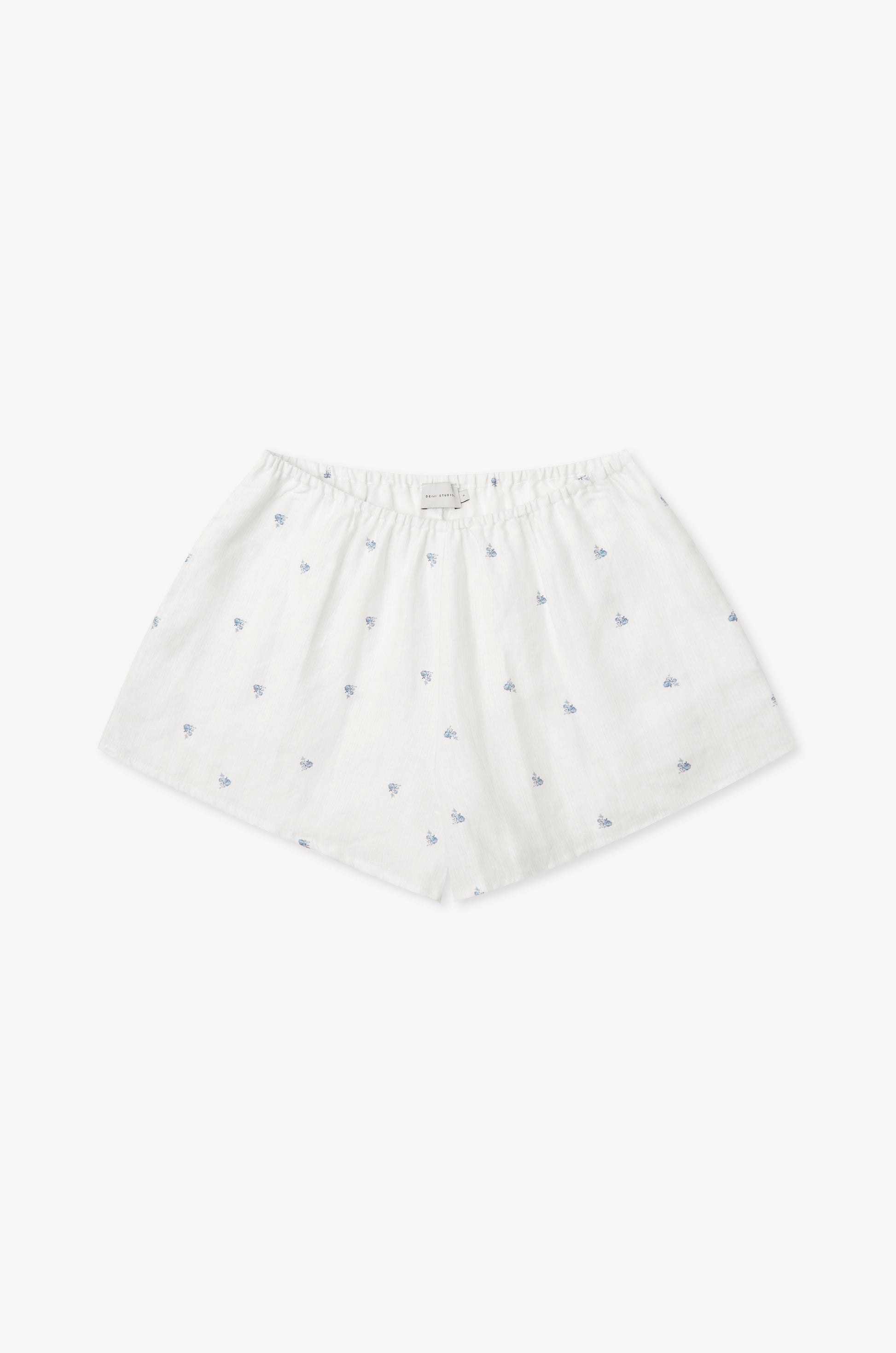 The Relax Short Set - Floral Blue features white cotton boxer shorts with a loose fit, elastic waistband, and delicate blue floral patterns, reminiscent of Deiji Studios' signature comfort, shown against a plain white background.