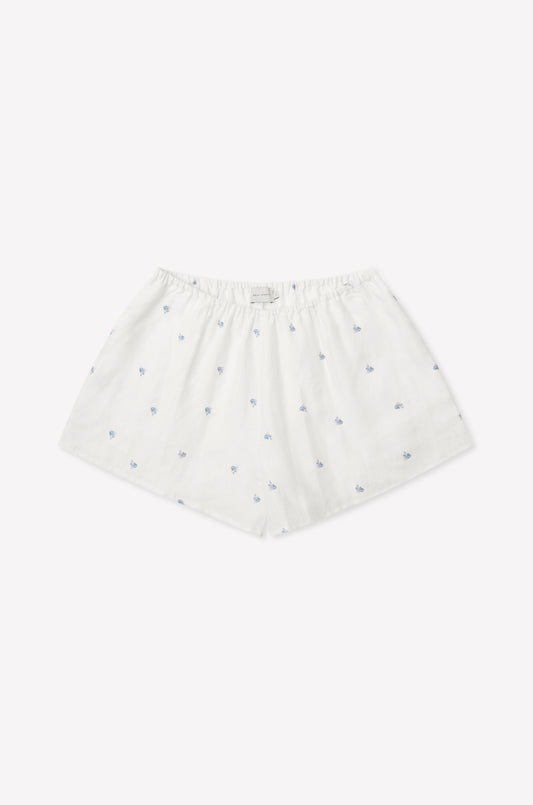 The Relax Short Set - Floral Blue features white cotton boxer shorts with a loose fit, elastic waistband, and delicate blue floral patterns, reminiscent of Deiji Studios' signature comfort, shown against a plain white background.