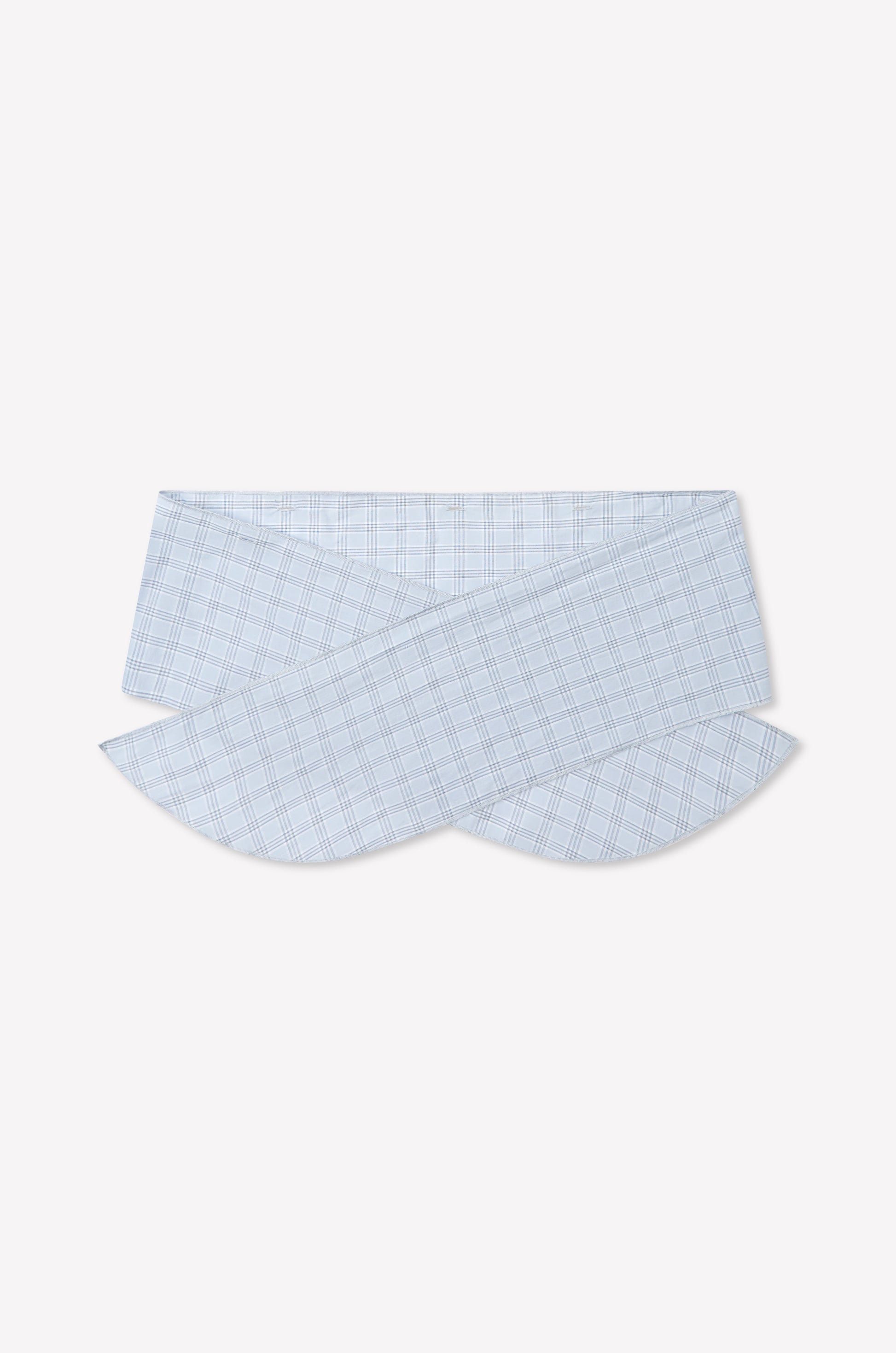 The Flow Top - Powder Check features a light blue and white plaid fabric, showcasing a unique overlapping and curved collar inspired by Deiji Studios, displayed on a plain white background. Includes a removable scarf panel for versatile styling.