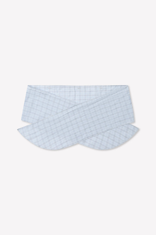 The Flow Top - Powder Check features a light blue and white plaid fabric, showcasing a unique overlapping and curved collar inspired by Deiji Studios, displayed on a plain white background. Includes a removable scarf panel for versatile styling.