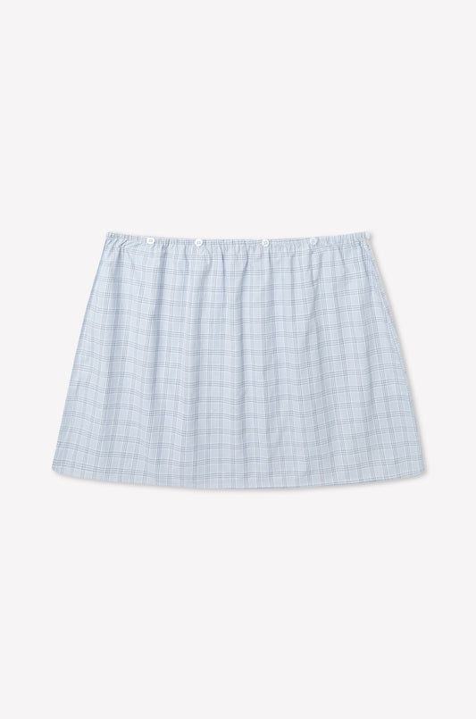 A light blue plaid Flow Top in Powder Check, inspired by Deiji Studios, with a straight hem and elastic waistband, displayed on a plain white background.