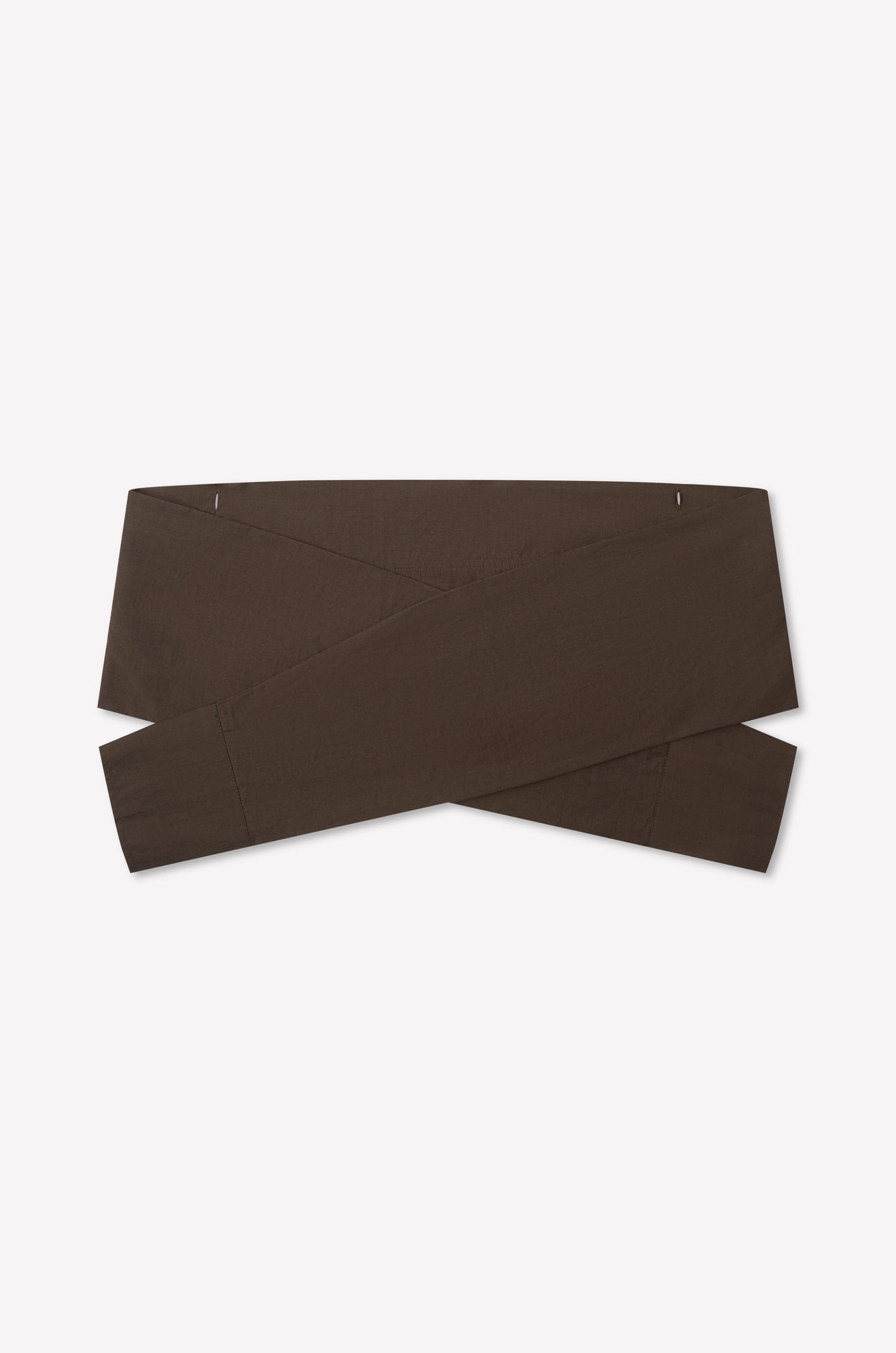 The Shirt Cuff Belt - Toast by Deiji Studios is a wide, dark brown cotton poplin belt with a crisscross design, shown flat on a white background.