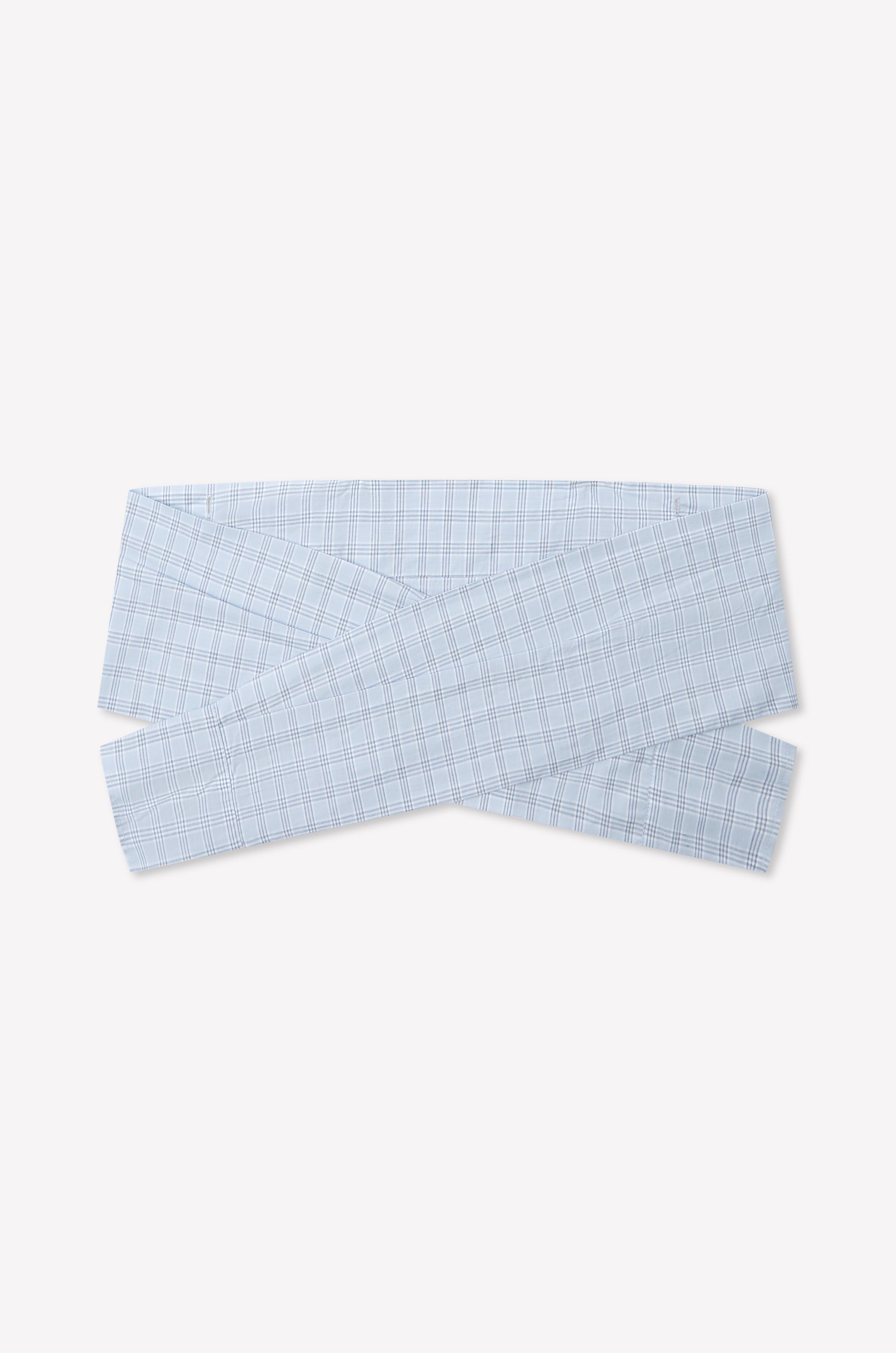 The Shirt Cuff Belt - Powder Check is a light blue plaid cotton poplin belt with a crisscross wrap design, inspired by Deiji Studios, shown on a plain white background.