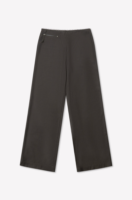 The Pure Wool Zip Pant - Charcoal Stripe features a high-waisted, wide-leg fit in pure wool with a subtle stripe, zipper and button closure, and a small zip pocket on the left side. Shown laid flat on a white background.