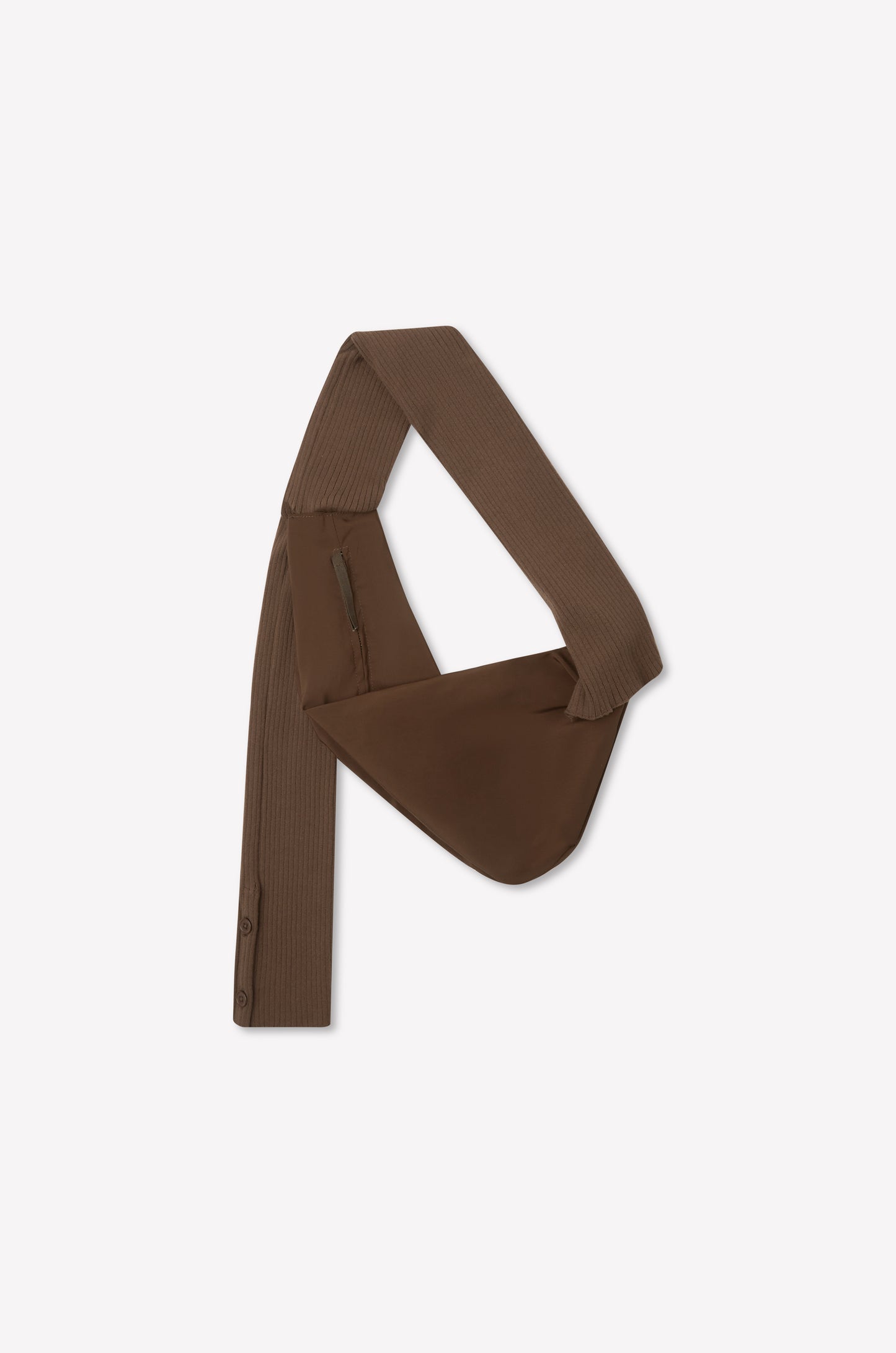 The Knit Strap Bag - Hazel is a brown, asymmetrical bag with a wide ribbed knit strap, zippered pocket, and button details on one end, displayed flat on a white background.