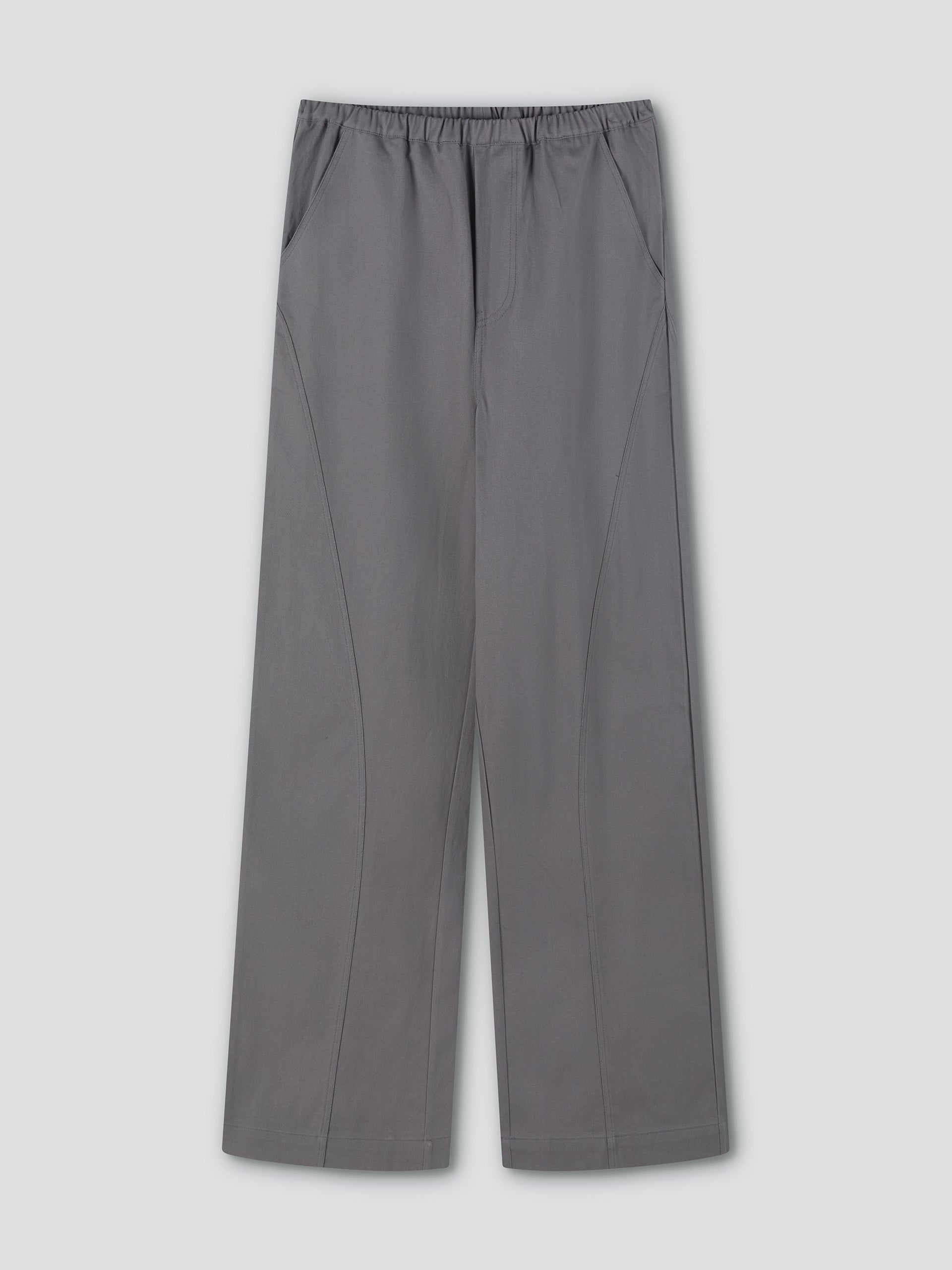 Curve Pant - Lavendar Smoke by Deiji Studios: wide-leg, relaxed fit trousers in lavender grey with curved seams, elastic waistband, and side pockets. Shown flat on a light grey background.