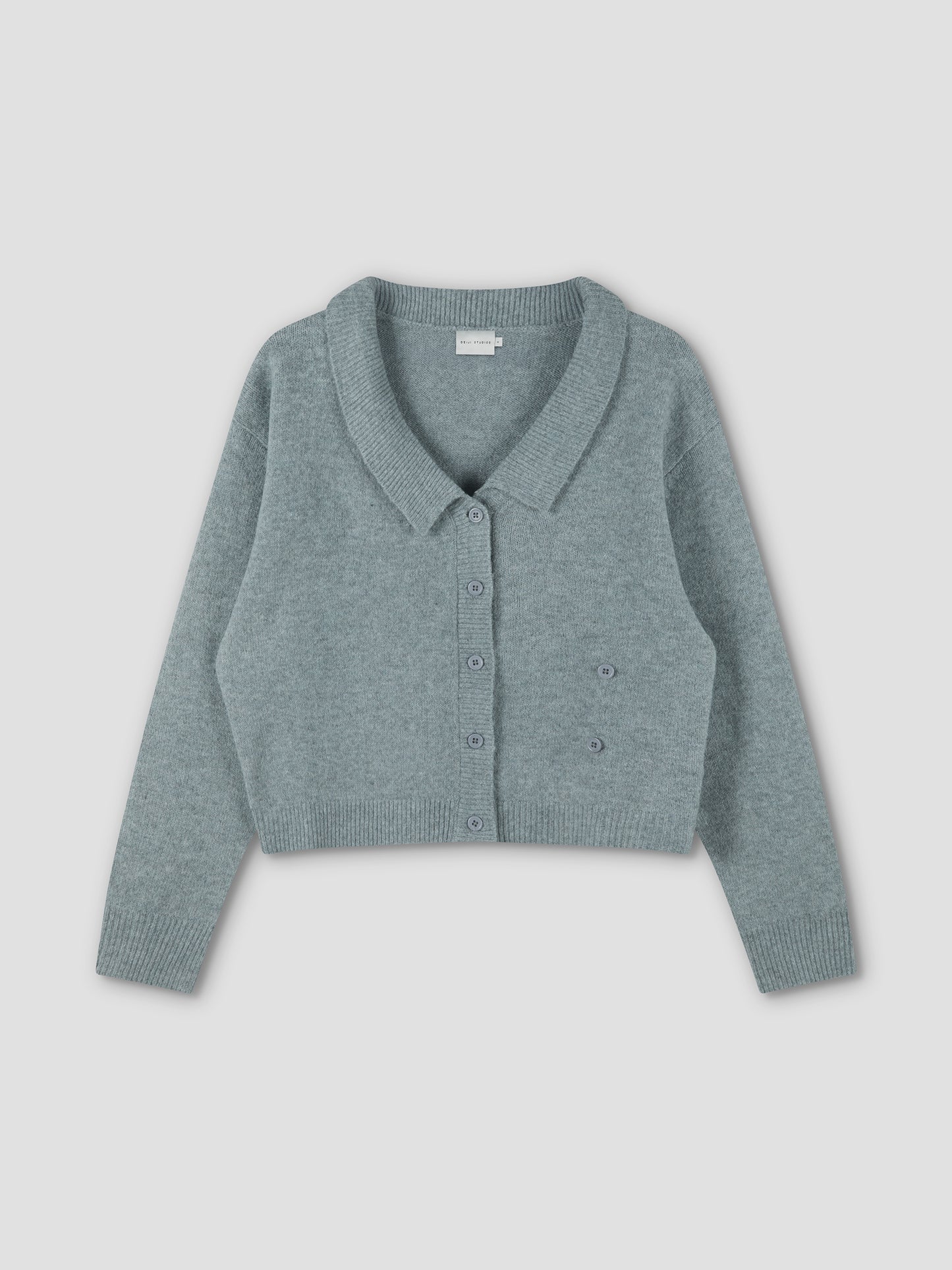The Cross Button Cardigan - Ice Blue is a light blue-green, long-sleeve, cropped knit with a collar and cross front button closure, shown flat on a plain light background.