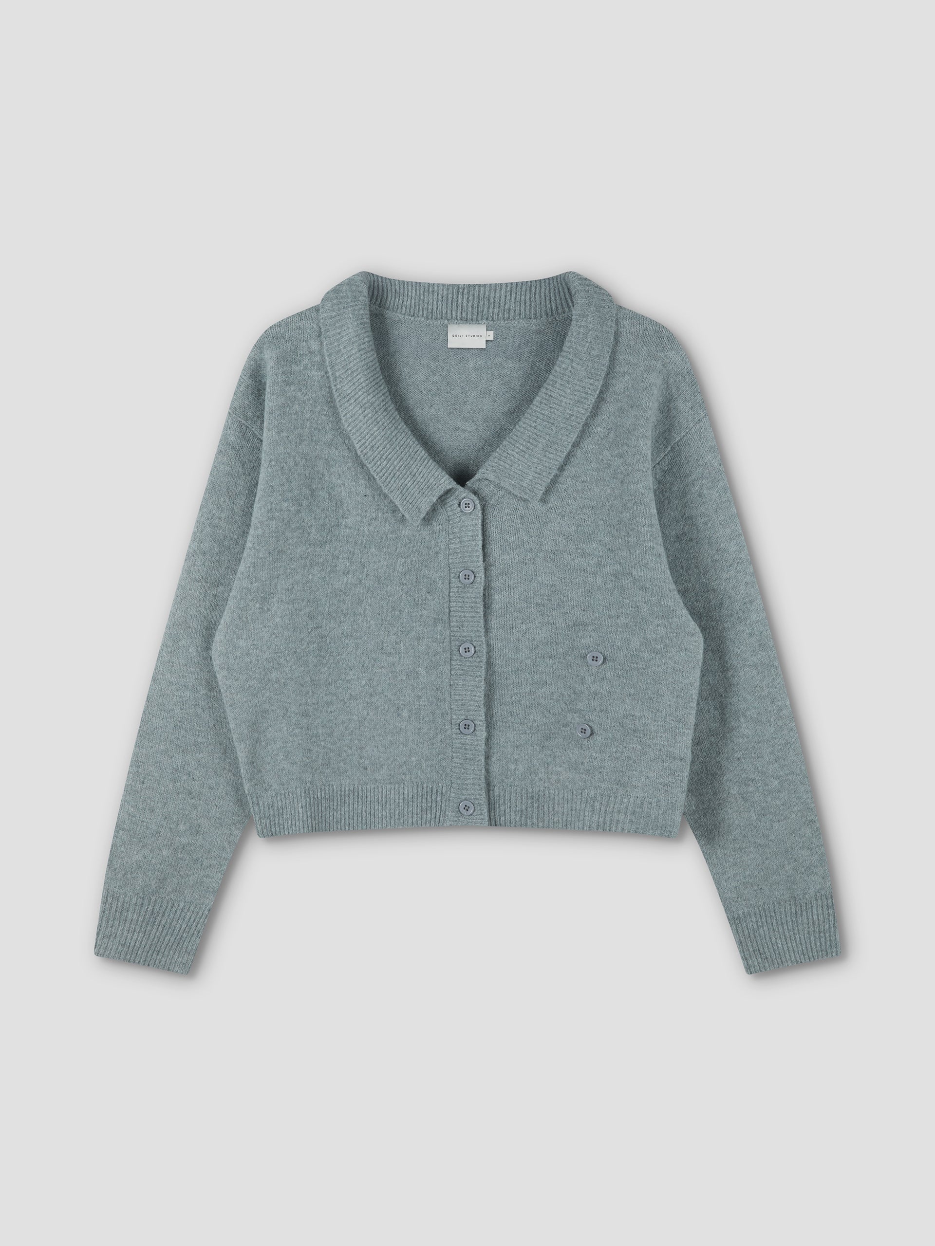 The Cross Button Cardigan - Ice Blue is a light blue-green, long-sleeve, cropped knit with a collar and cross front button closure, shown flat on a plain light background.