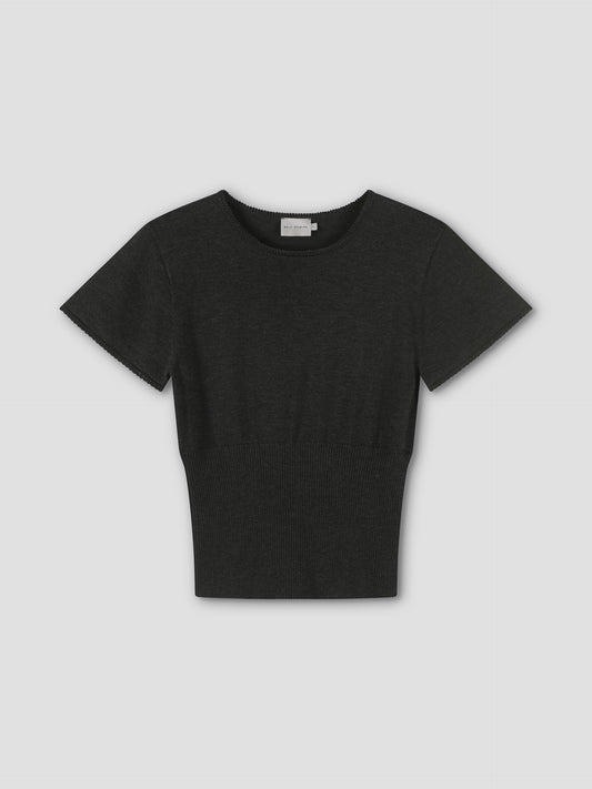 The Trim Knit Tee - Dark Grey features short sleeves, a round neckline, and a fitted ribbed waist in Deiji Studios’ minimalist style. Shown against a light gray background.