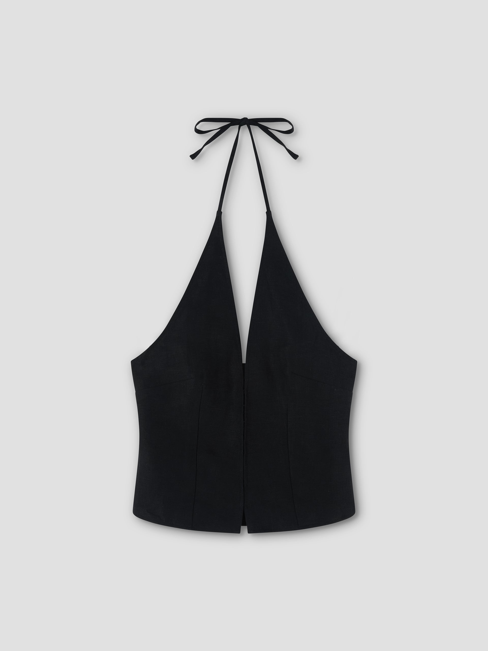 A Close Halter Top - Black by Deiji Studios, featuring a deep V neckline and tie closure at the neck, is displayed flat on a light gray background.
