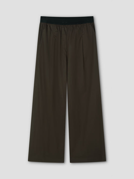 The Contrast Waist Pant - Brown by Deiji Studios features a black elastic waistband, side pockets, and a relaxed straight leg fit. Shown laid flat on a light gray background.