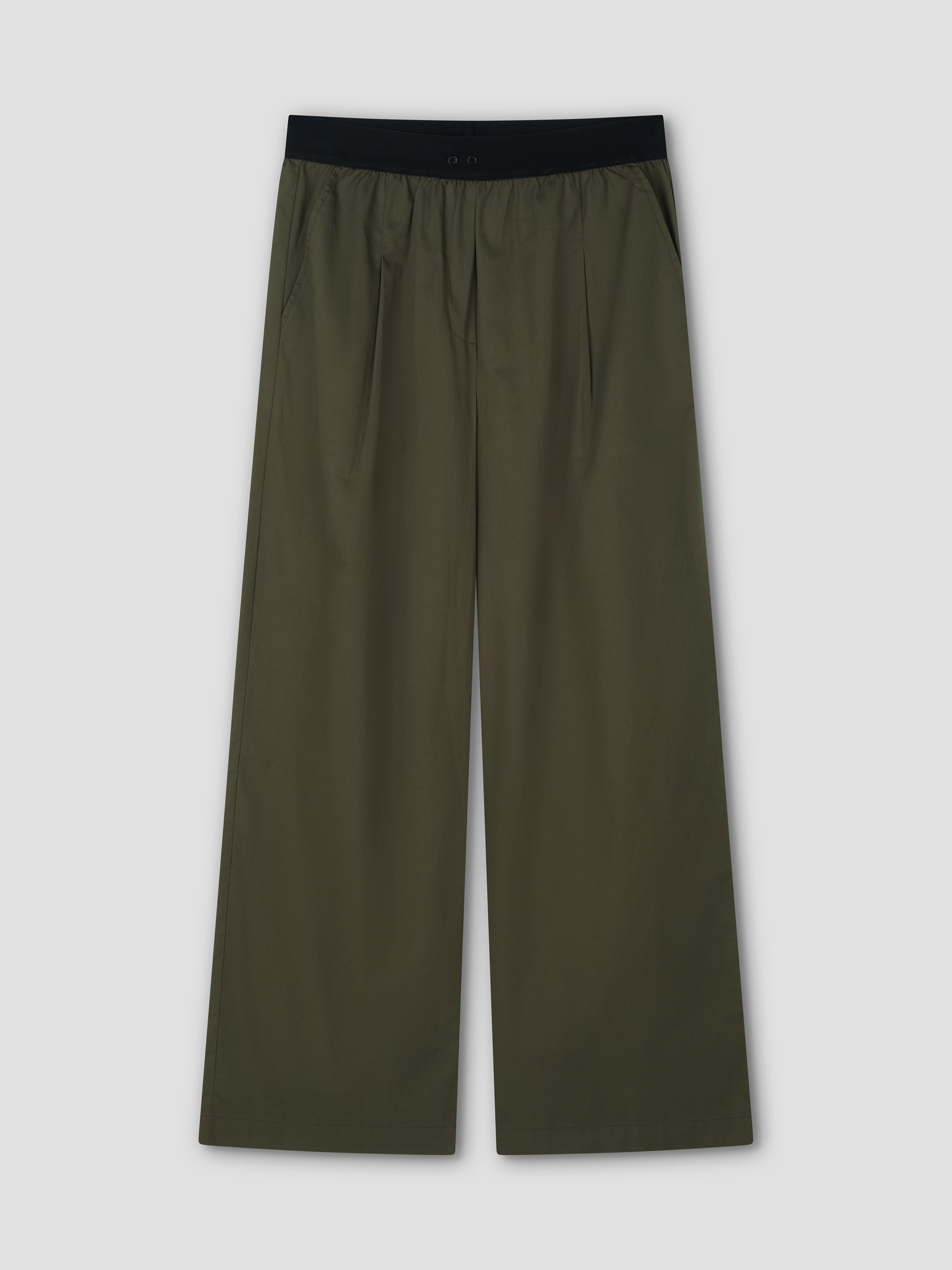 The Contrast Waist Pant - Olive by Deiji Studios, featuring a black elastic waistband, front pleats, and side pockets, is shown laid flat on a light gray background.