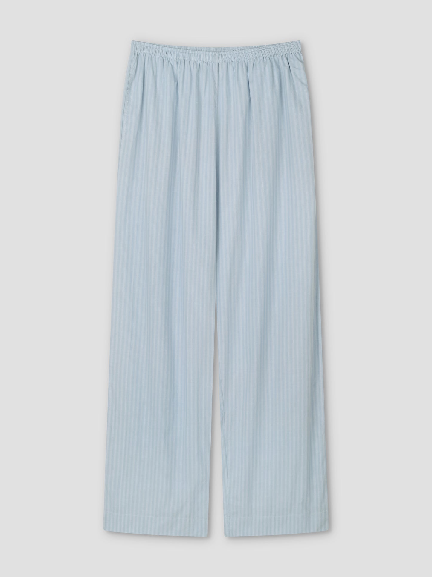 The Ease Trouser - Lake Blue Stripe pajama pants feature light blue and white vertical stripes, a relaxed fit, and an elastic waistband, shown flat on a white background.