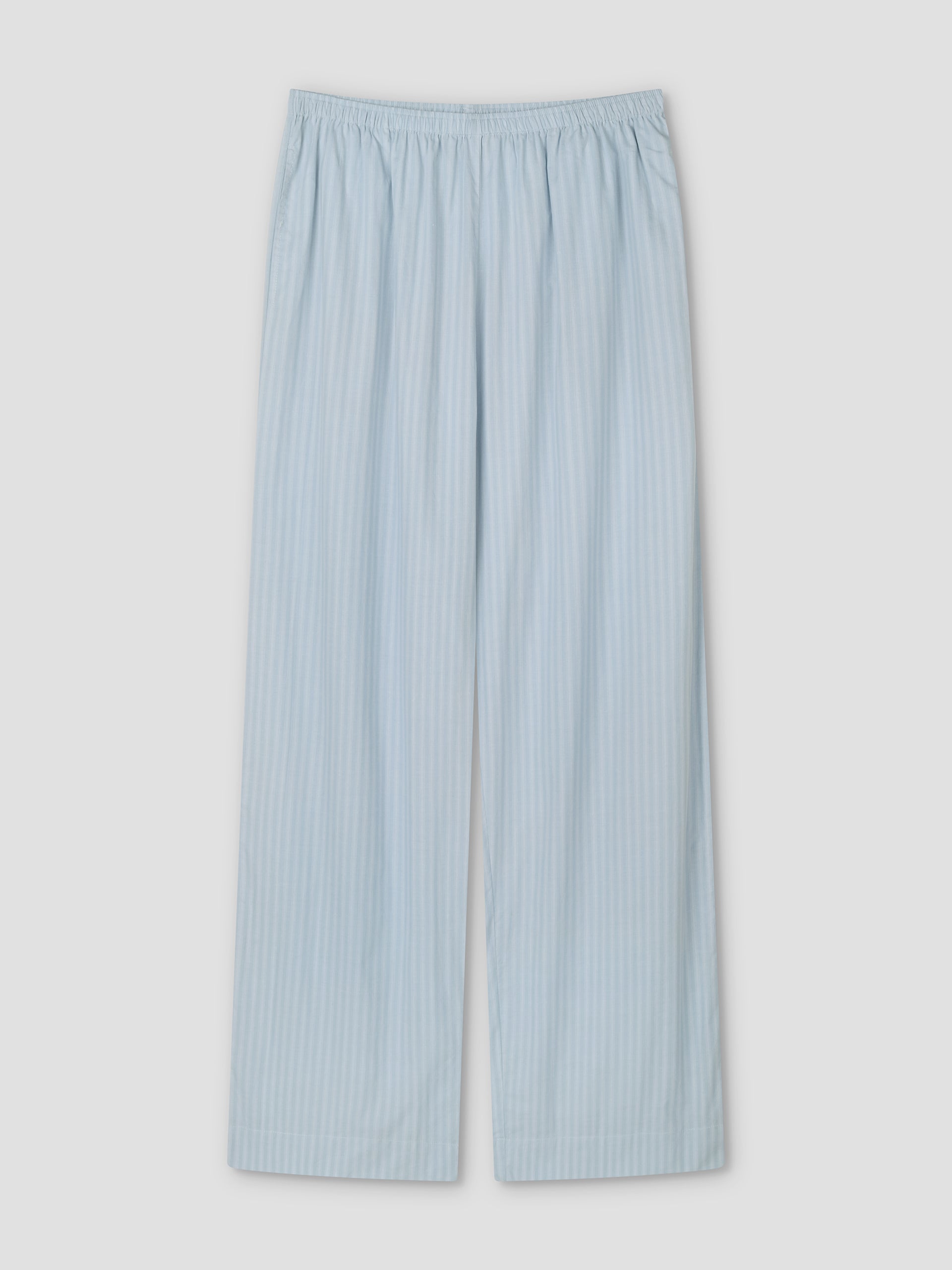 The Ease Trouser - Lake Blue Stripe pajama pants feature light blue and white vertical stripes, a relaxed fit, and an elastic waistband, shown flat on a white background.