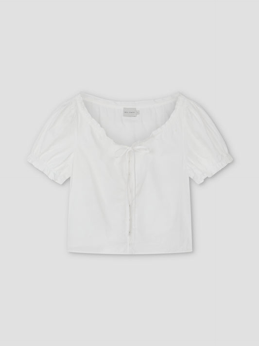 Close Shirt - White: A cropped short sleeve shirt with a scoop neckline, front tie detail, and gathered puff sleeves. Laid flat on a light gray background, this relaxed fit offers a stylish, comfortable option for casual looks.
