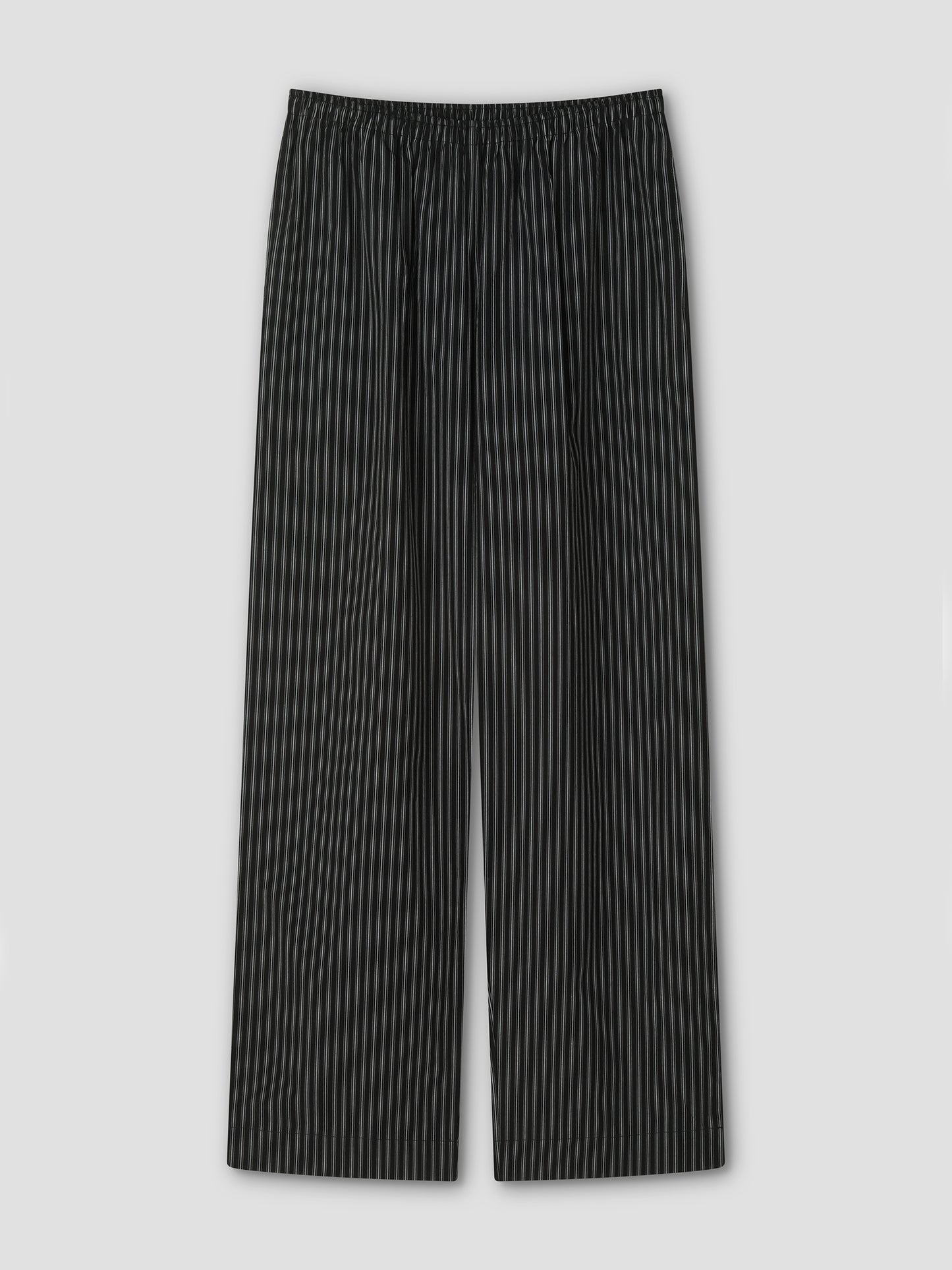 The Ease Trouser - Mono Stripe by Deiji Studios features black ankle-length design with thin white vertical pinstripes, an elastic waistband, and wide legs for a relaxed fit, shown flat on a light gray background.