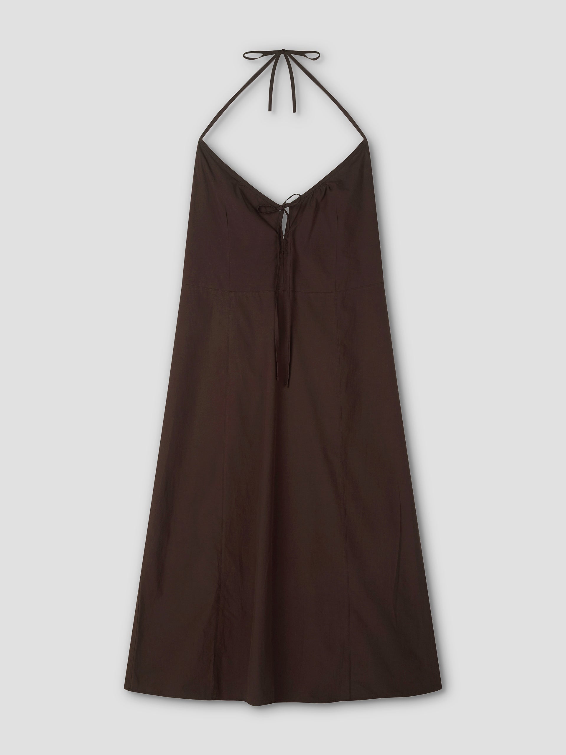 The Seamed Halter Dress - Sepia by Deiji Studios is a sleeveless, dark brown (sepia) A-line midi dress featuring seamed details, a V-neckline, and thin halter straps that tie at the neck. Shown against a light gray background.