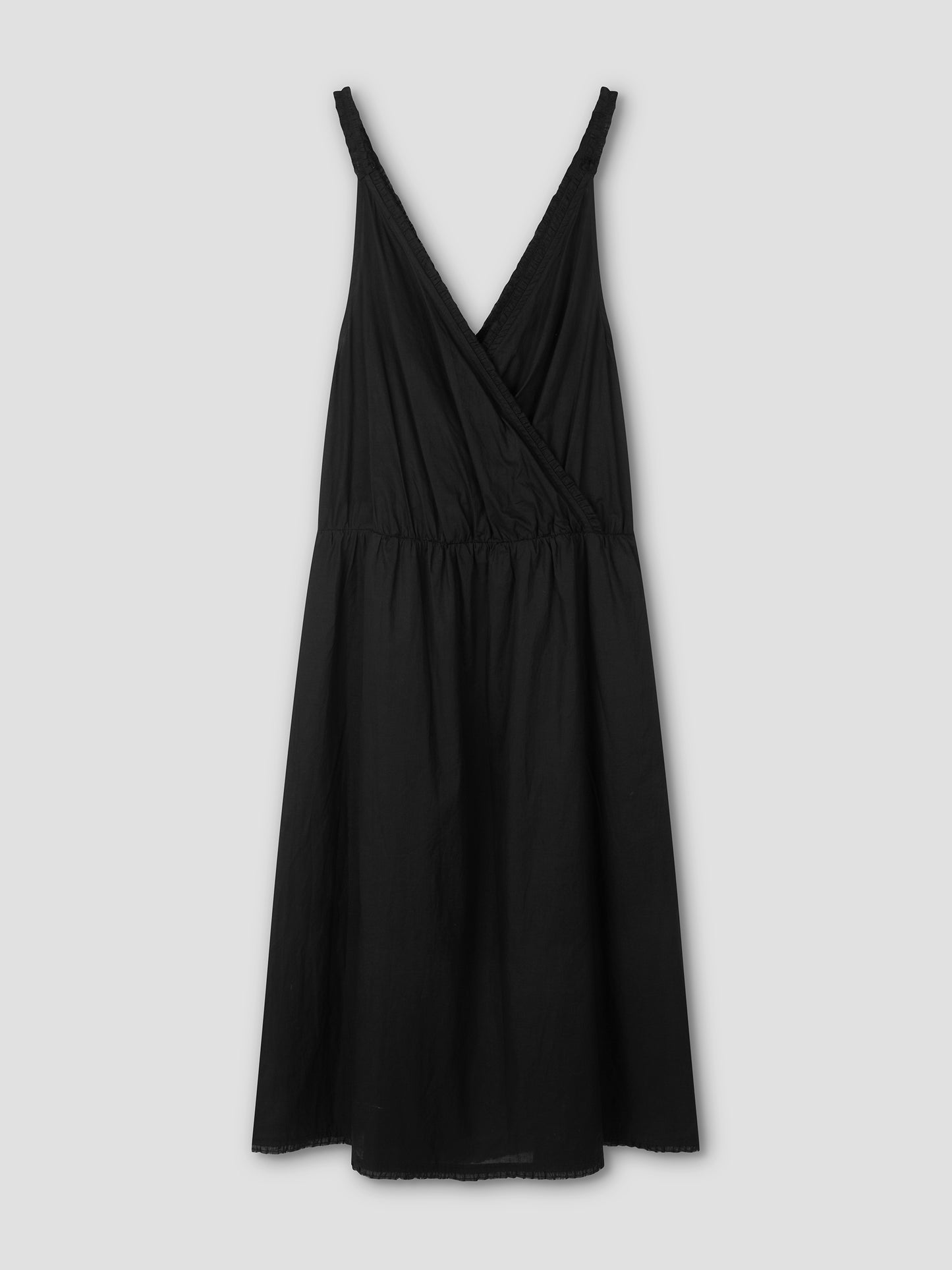 The Crossed Dress - Black is a sleeveless, V-neck wrap-style midi dress with a gathered waist, shown flat on a light gray background. This chic dress offers versatile styling options.