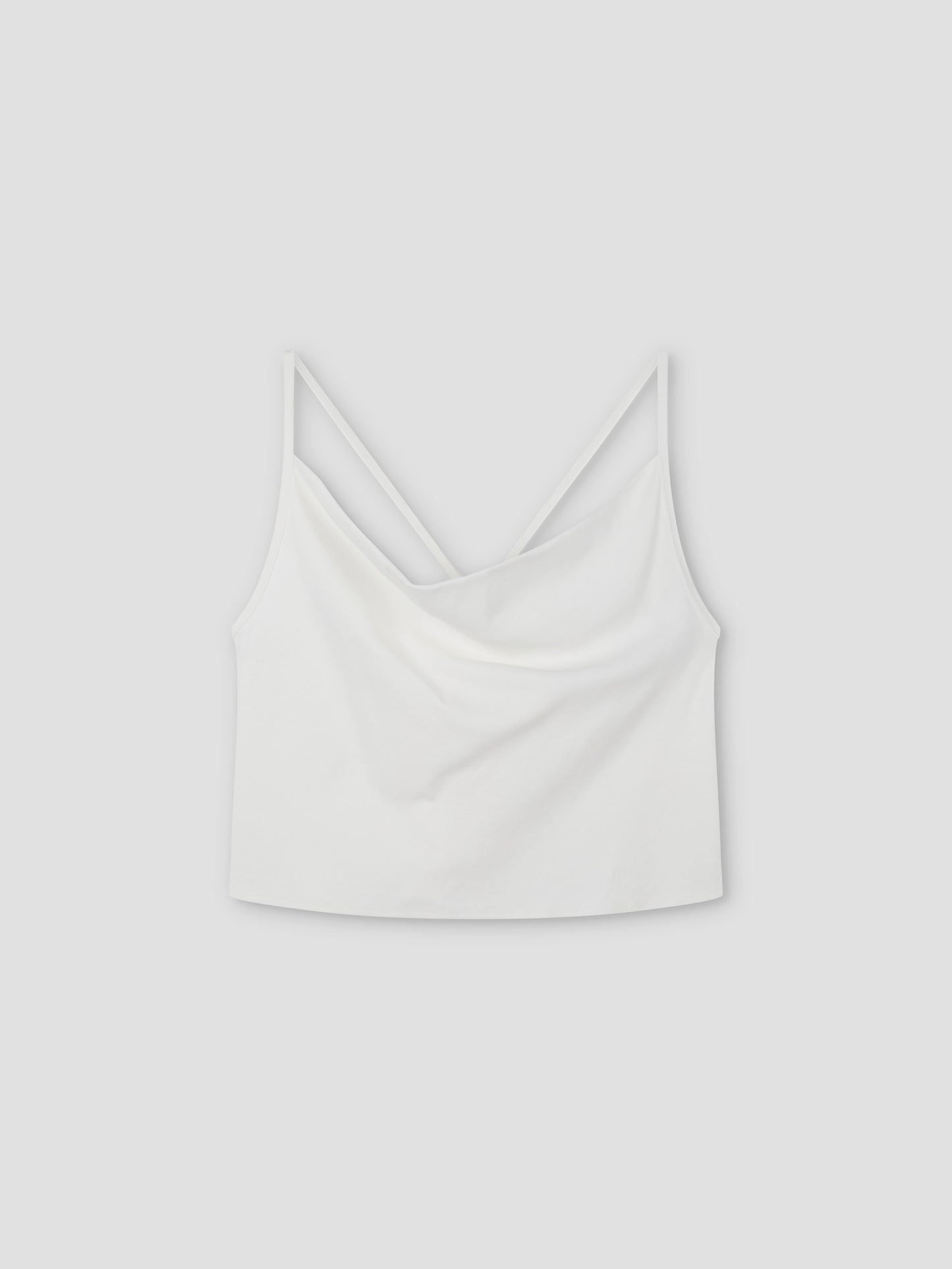 Drape Jersey Top: White sleeveless crop top with thin spaghetti straps and a softly draped neckline, shown on a light grey background.