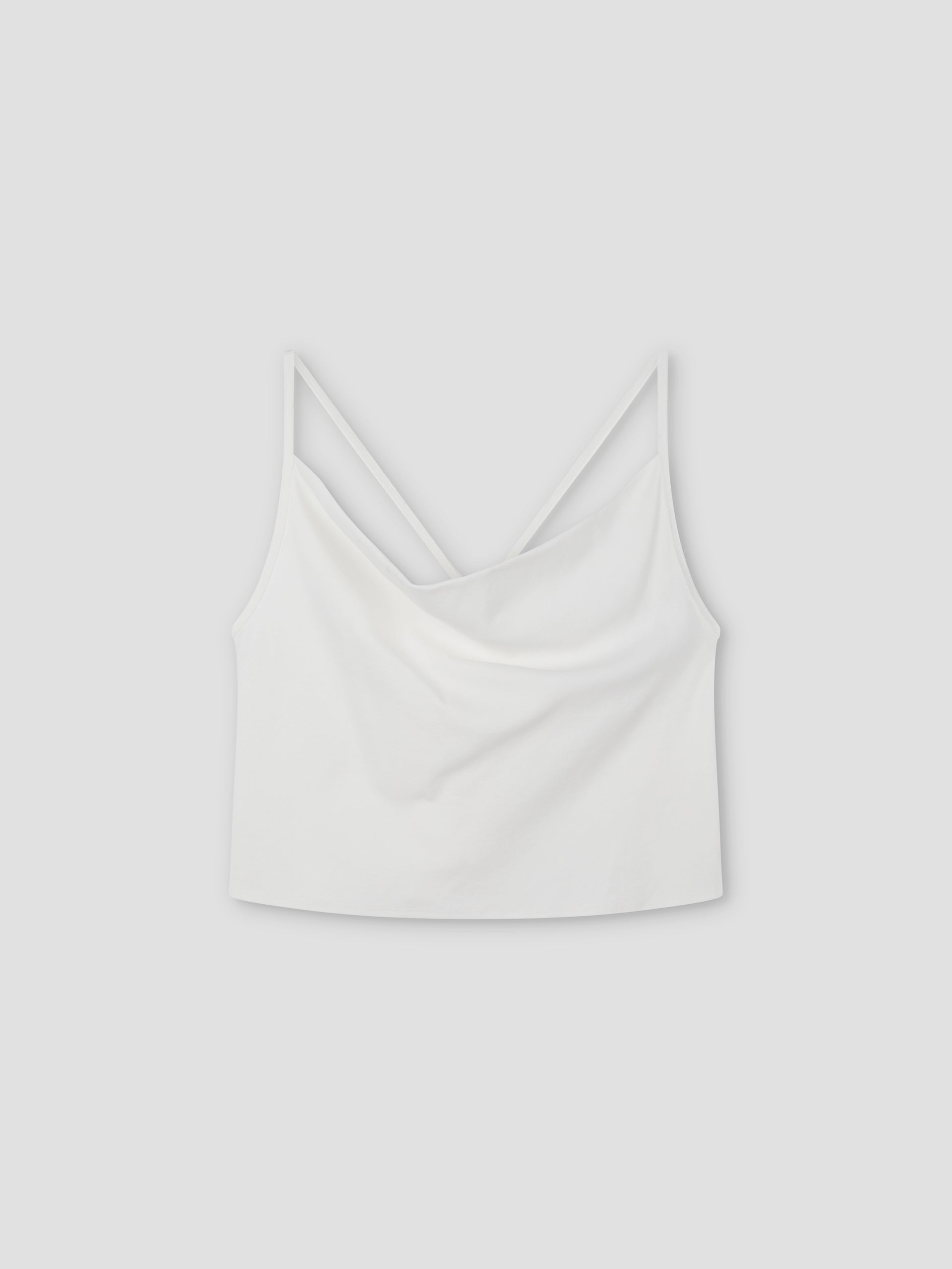 Drape Jersey Top: White sleeveless crop top with thin spaghetti straps and a softly draped neckline, shown on a light grey background.
