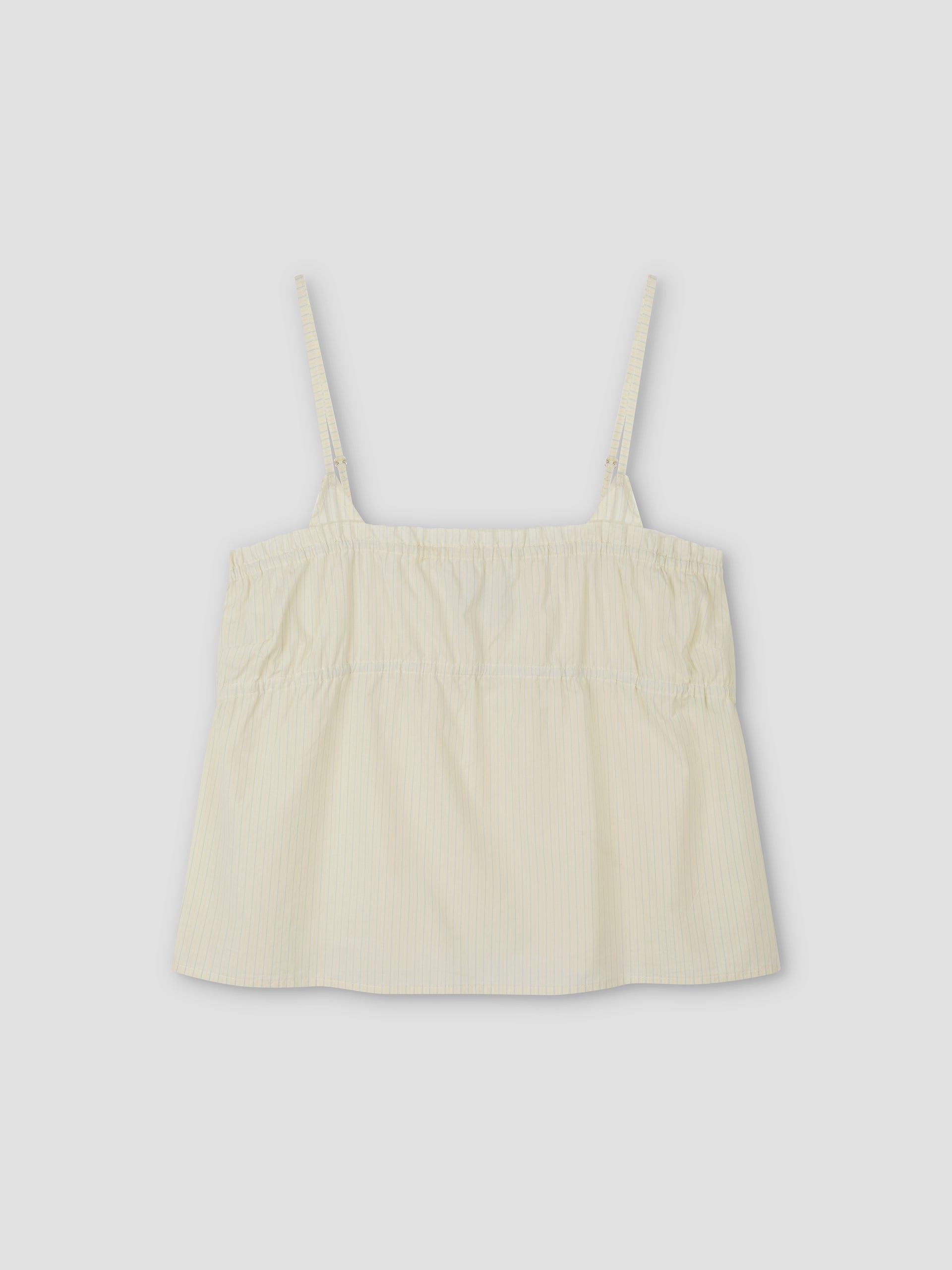 The Tri Cami - Citrus Stripe by Deiji Studios is a light yellow, sleeveless top with thin adjustable straps, a loose gathered fit, and lightweight fabric, shown against a plain light gray background.
