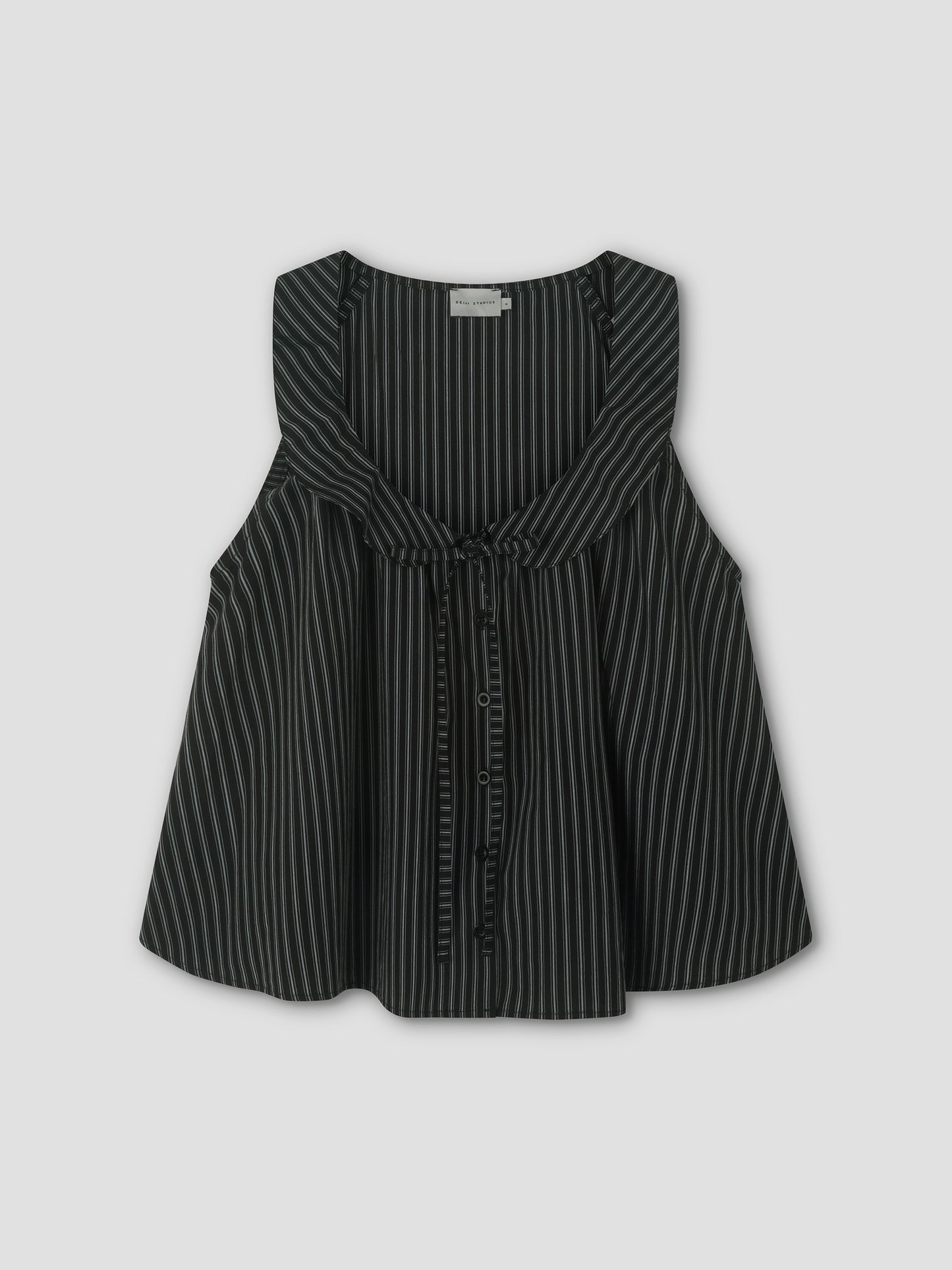 The Round Collar Top - Mono Stripe is a sleeveless black top with white vertical pinstripes, featuring a ruffled round collar and front tie detail, inspired by Deiji Studios. Displayed against a light gray background.