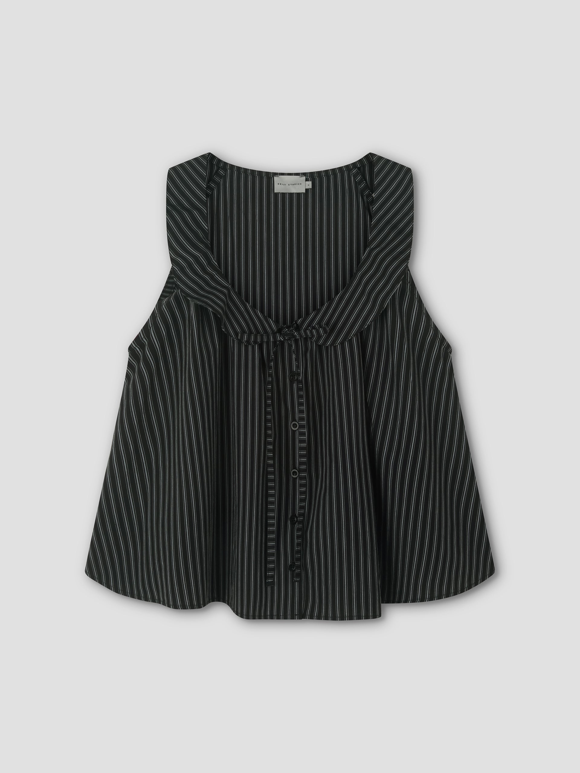 The Round Collar Top - Mono Stripe is a sleeveless black top with white vertical pinstripes, featuring a ruffled round collar and front tie detail, inspired by Deiji Studios. Displayed against a light gray background.
