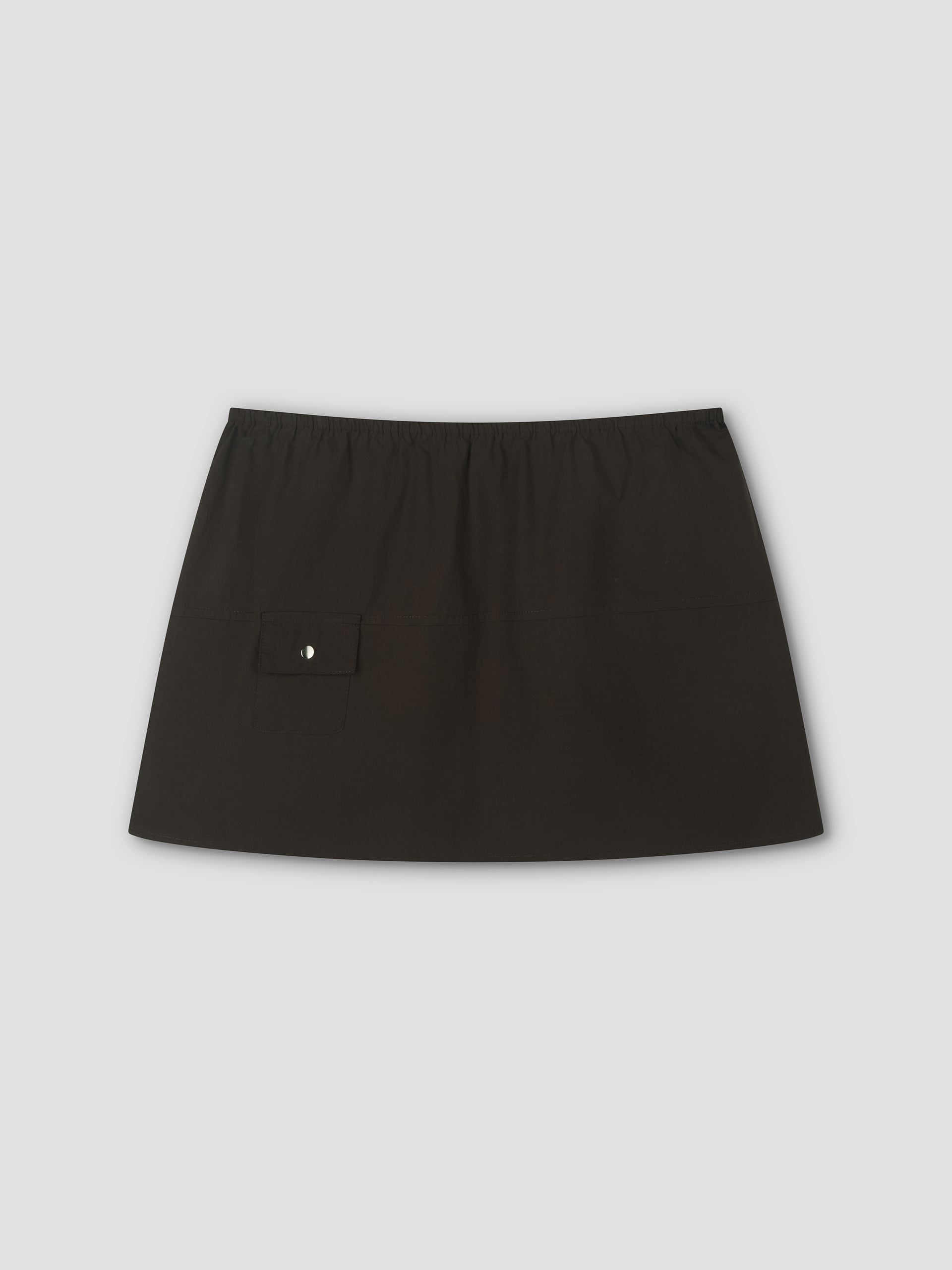 The Pocket Skirt - Sepia is a mini-length skirt with an elastic waistband and a small side pocket, shown against a light gray background.