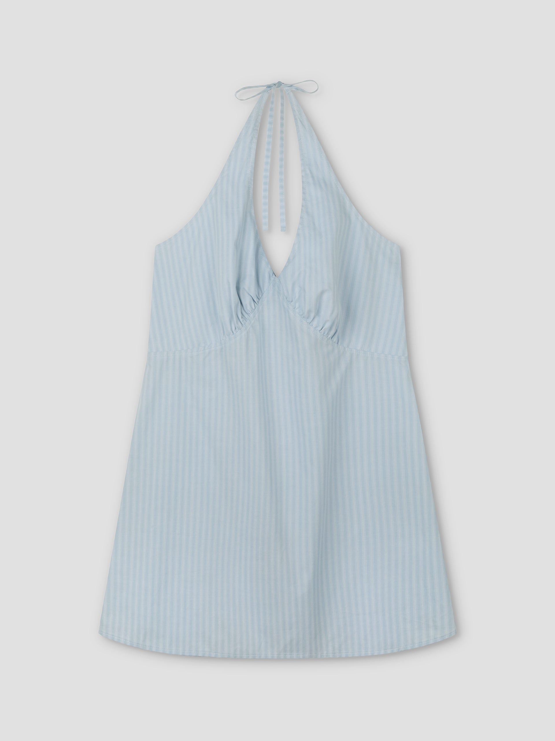 Cinched Halter Dress - Lake Blue Stripe from Deiji Studios, featuring light blue fabric with subtle vertical white stripes, a sleeveless design, gathered chest, and halter neck tie, shown laid flat on a white background.